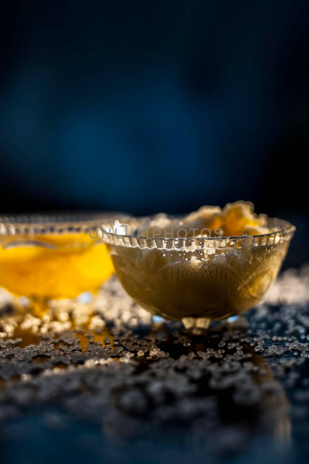 Close up shot of ayurvedic method or calcium supplement on the black surface consisting of raw eggs, milk, and ghee or clarified butter along with some sugar as a sweetener.