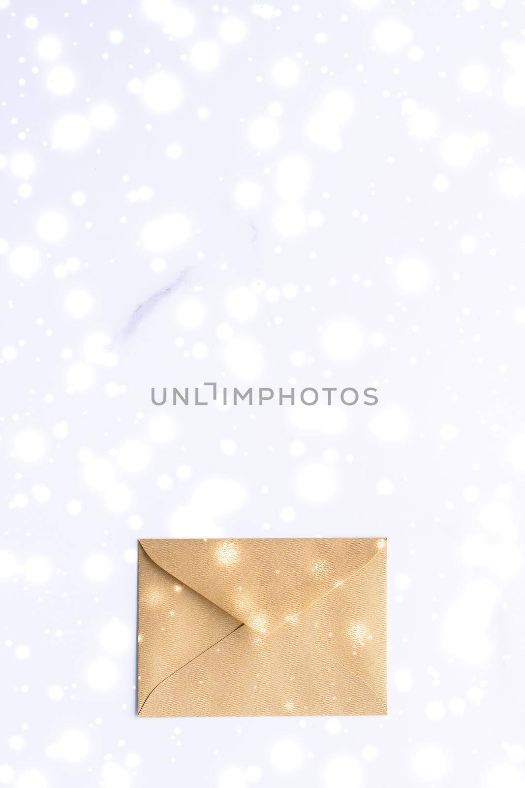 Greetings, postal service and online newsletter concept - Winter holiday blank paper envelopes on marble with shiny snow flatlay background, love letter or Christmas mail card design