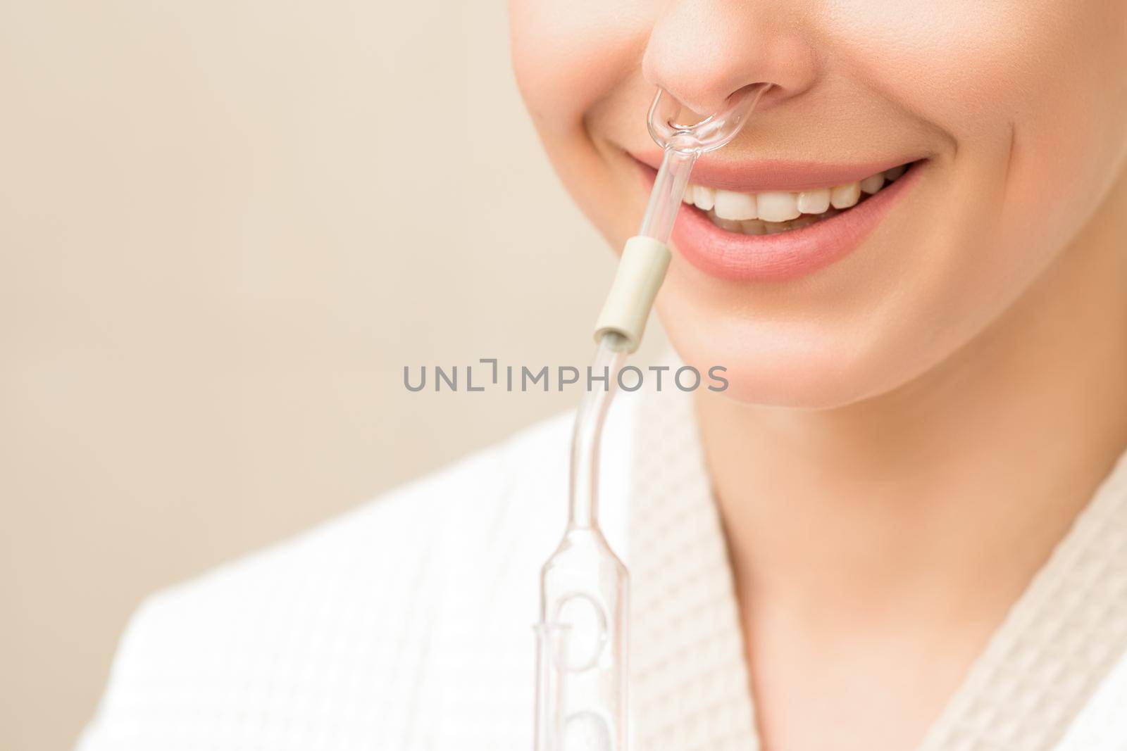 Beautiful happy young caucasian woman receiving nasal inhaler with essential oil smiling in a spa