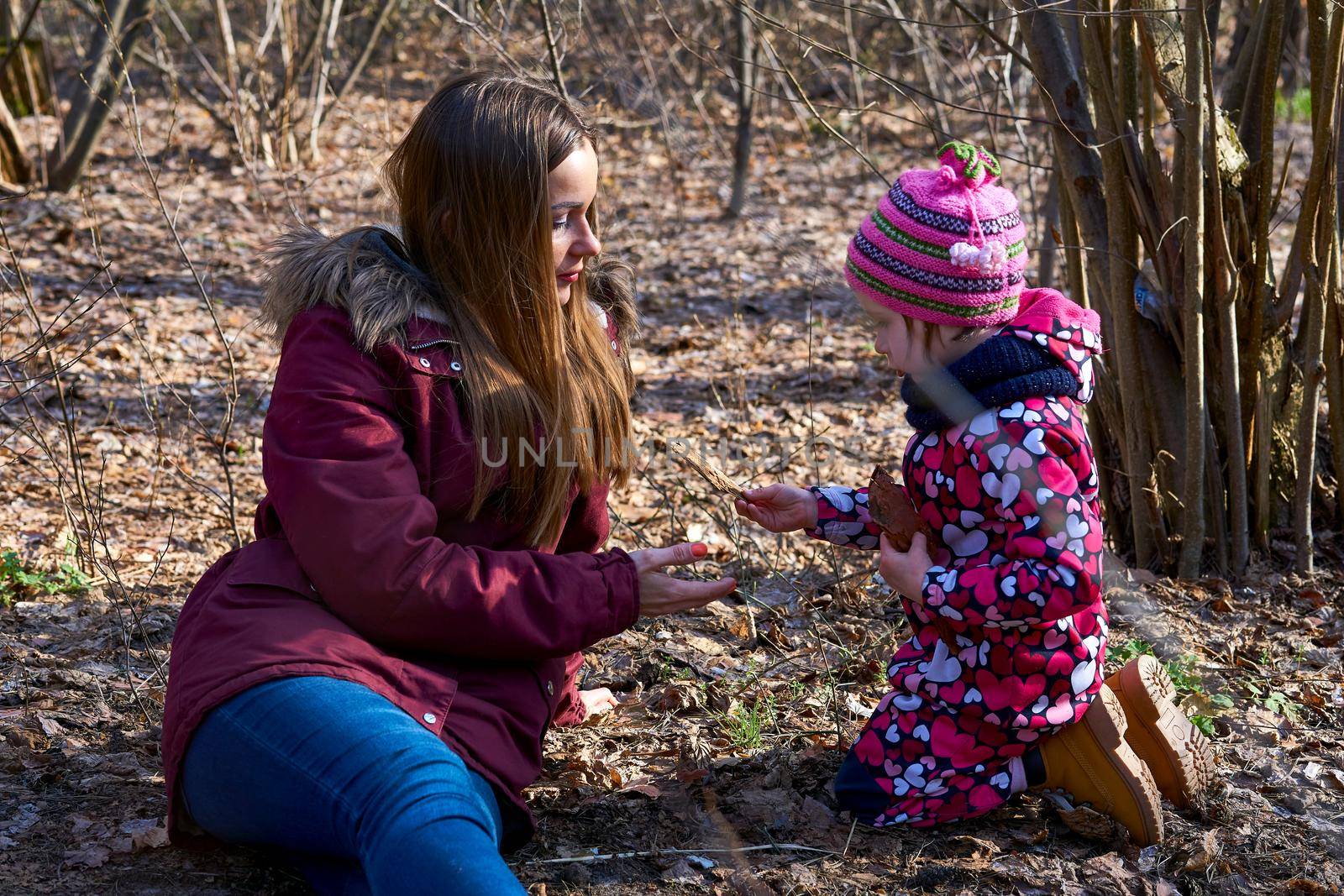 the process of receiving or giving systematic instruction, especially at a school or university. A young mother tells the child about the nature in the spring autumn forest .