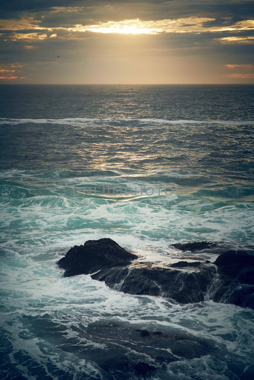 Let the sea set you free. ocean waves crashing against boulders on the seashore outdoors