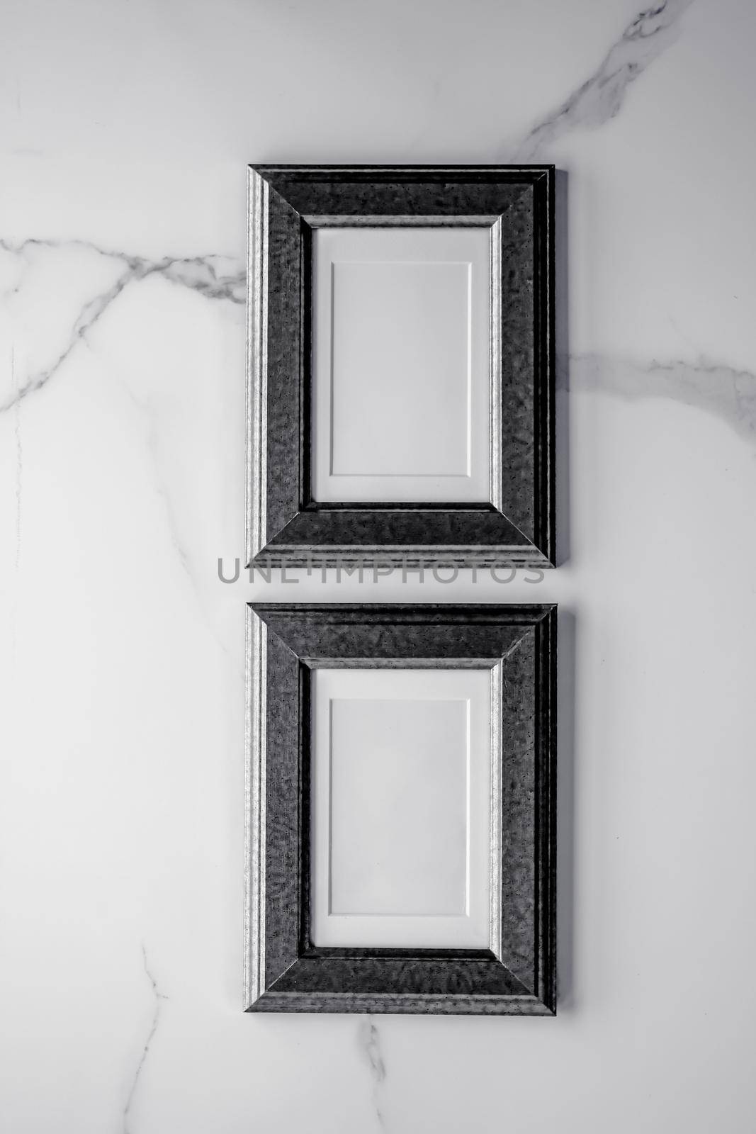 Black photo frame on marble, flatlay by Anneleven