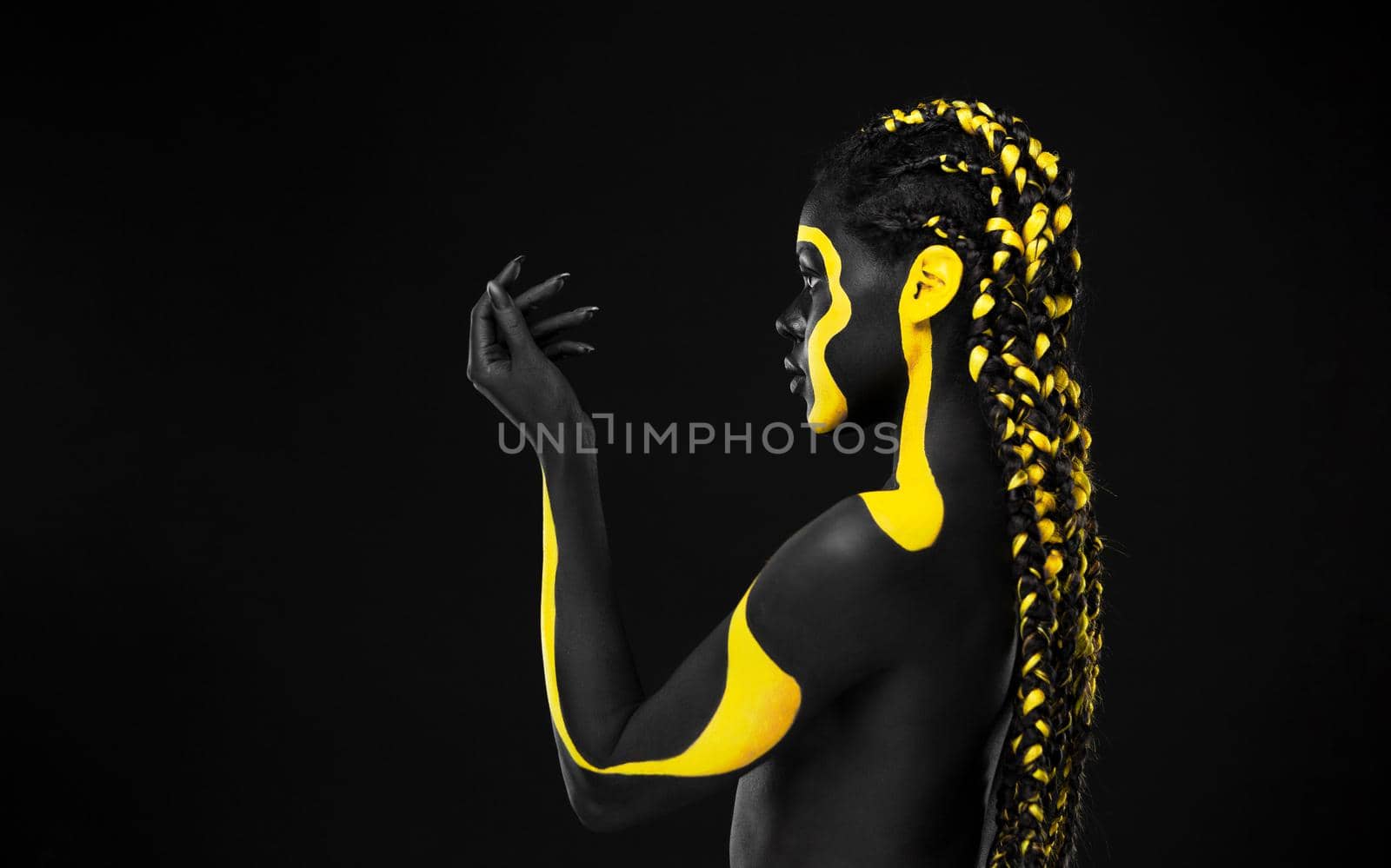 The Art Face. Black and yellow body paint on african woman. Abstract creative portrait. Bright fashion makeup on the girl. by MikeOrlov