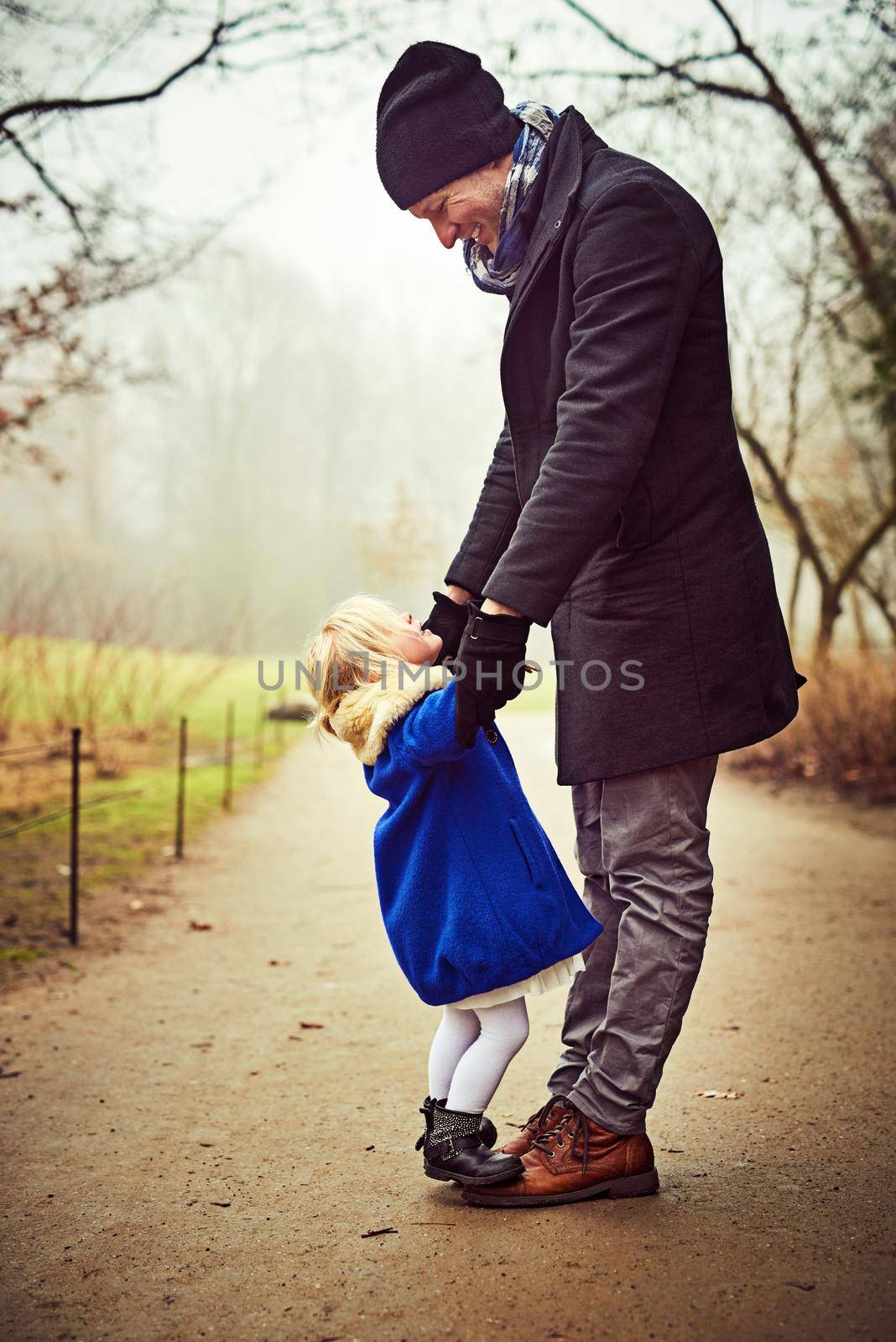 I love you my daughter. an adorable little girl with her father outdoors. by YuriArcurs