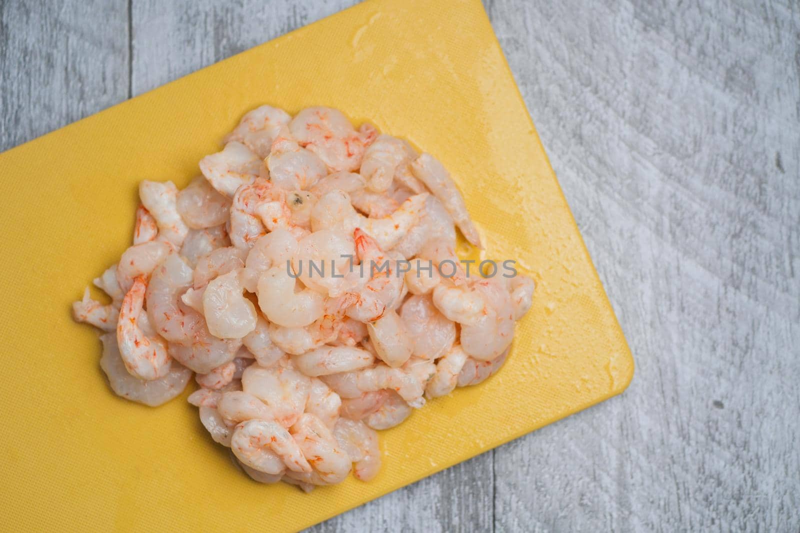 raw king prawn on a chopping board on table ,