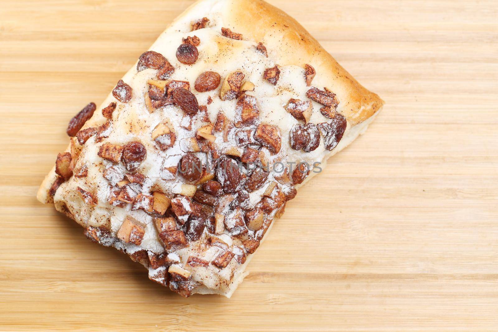 apple raisin bread on chopping board on table ,