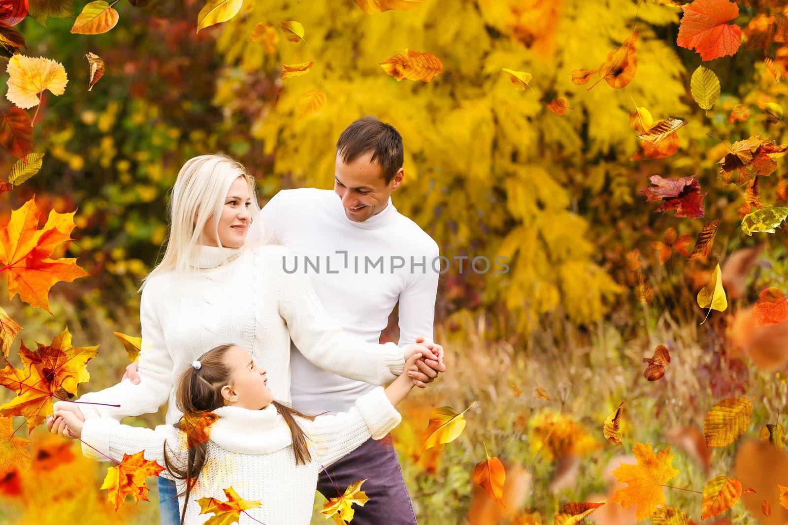 Family playing in autumn park having fun by Andelov13