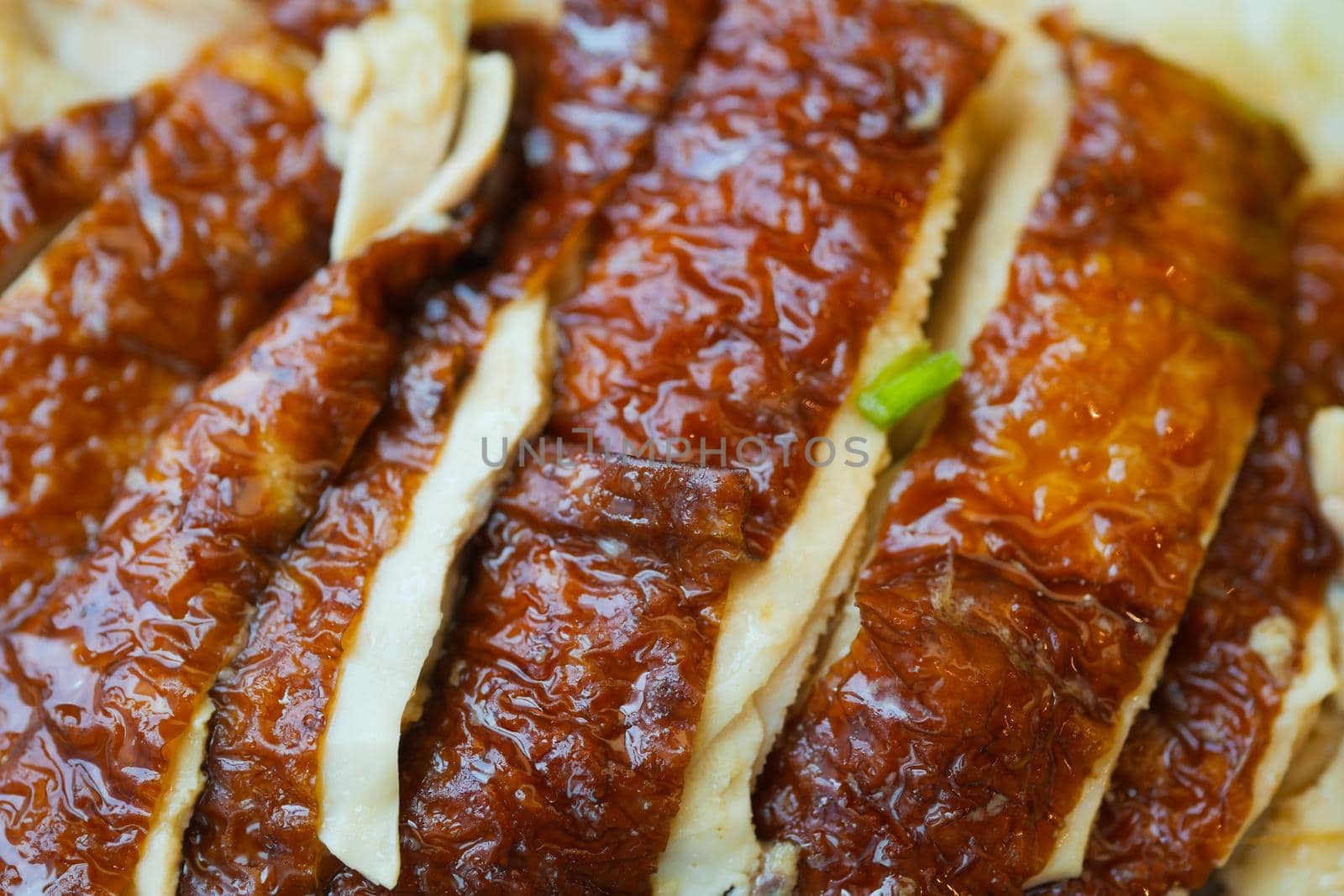 close up of slice of grill chicken on a plate .