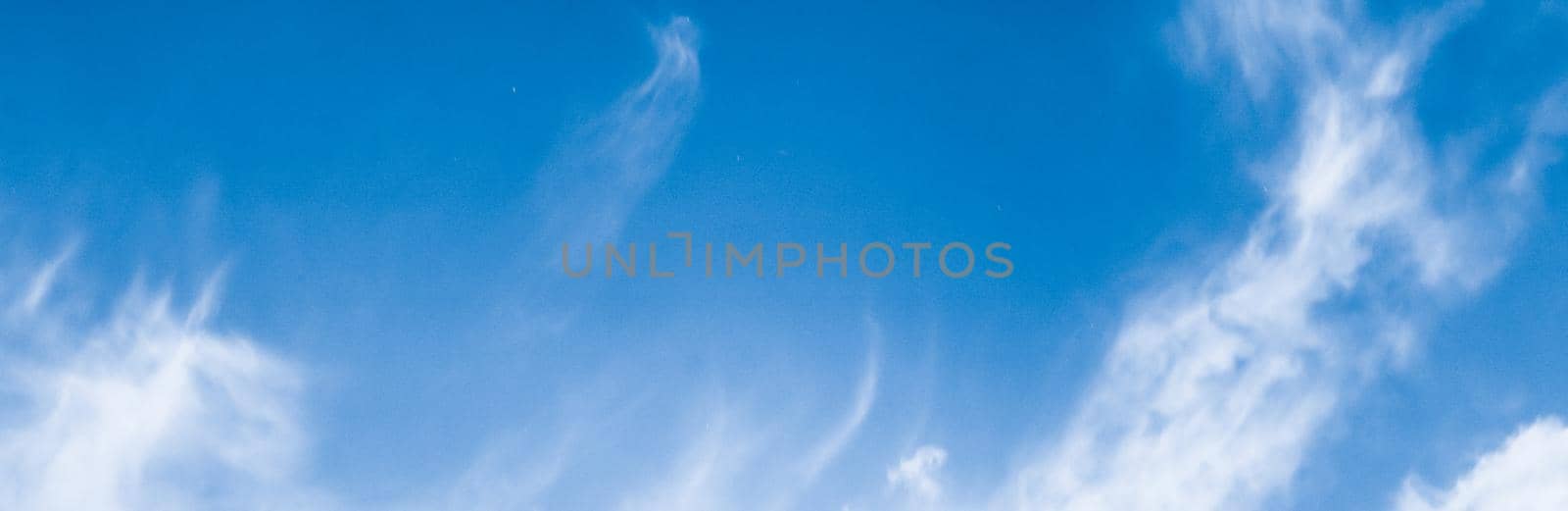 Blue sky background, white clouds and bright sunlight by Anneleven