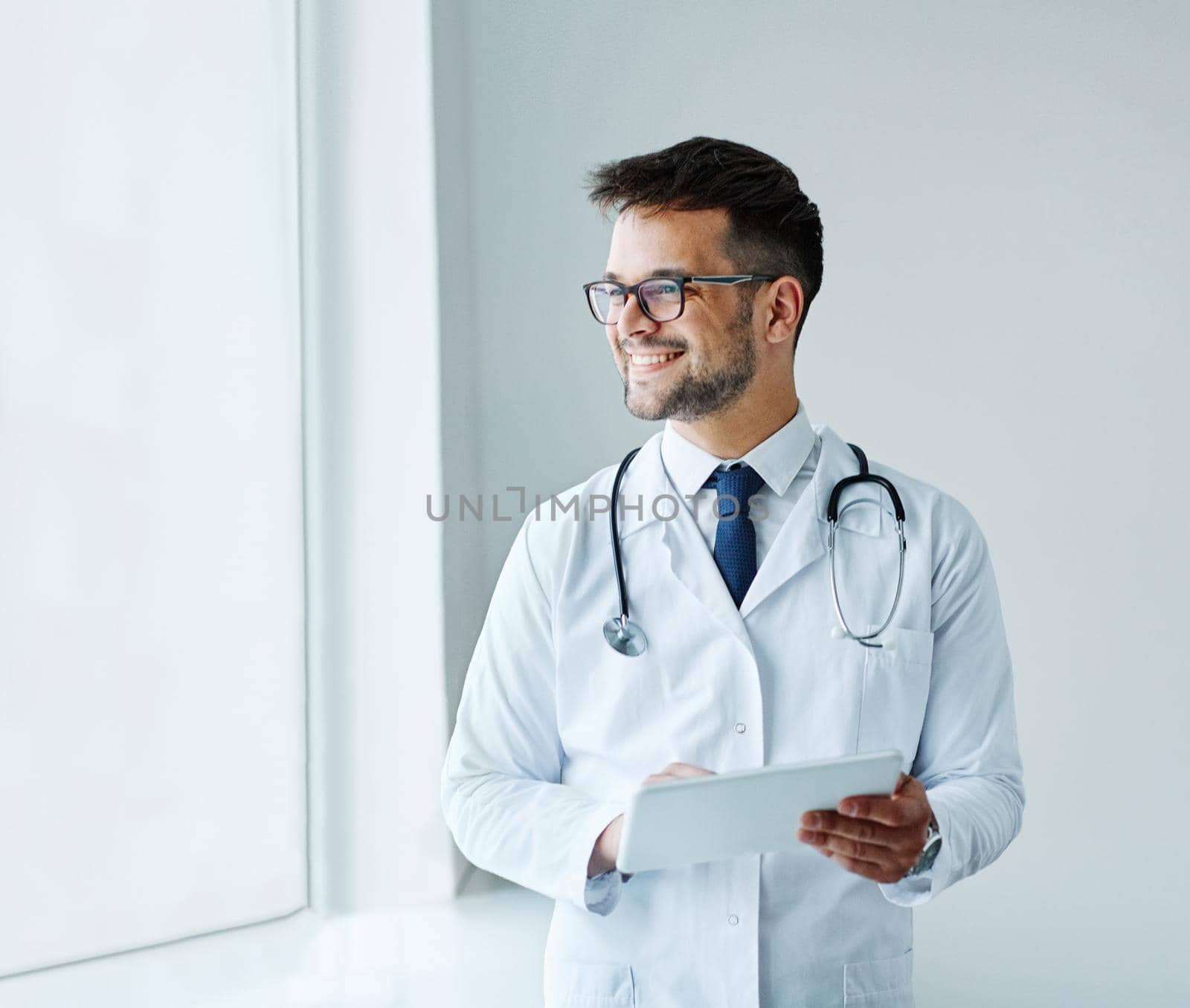 young doctor hospital medical medicine health care clinic office portrait glasses man stethoscope specialist tablet computer by Picsfive