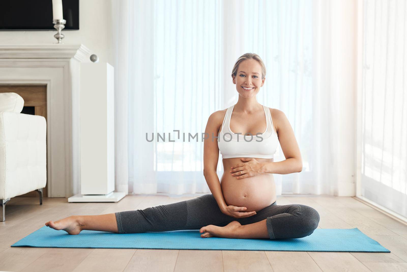 When Im healthy my babys healthy. a pregnant woman meditating on an exercise mat at home