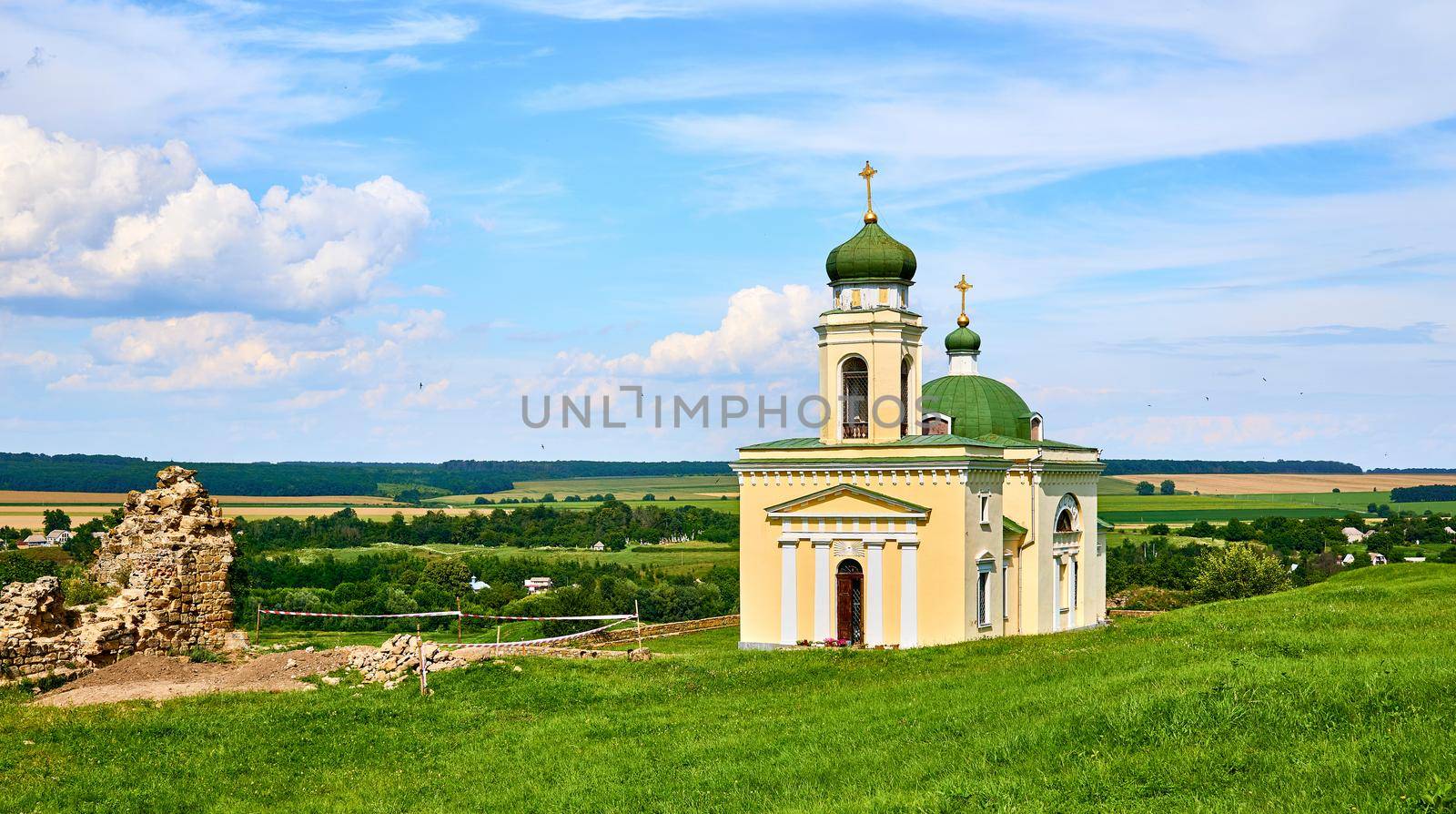 a building used for public Christian worship. Wonderful church and archeological site in a green field on a warm sunny day.