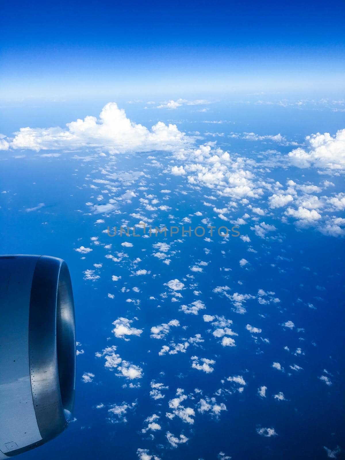 Travel, cloudscape and natural environment concept - View from the airplane window, sky and ocean blue