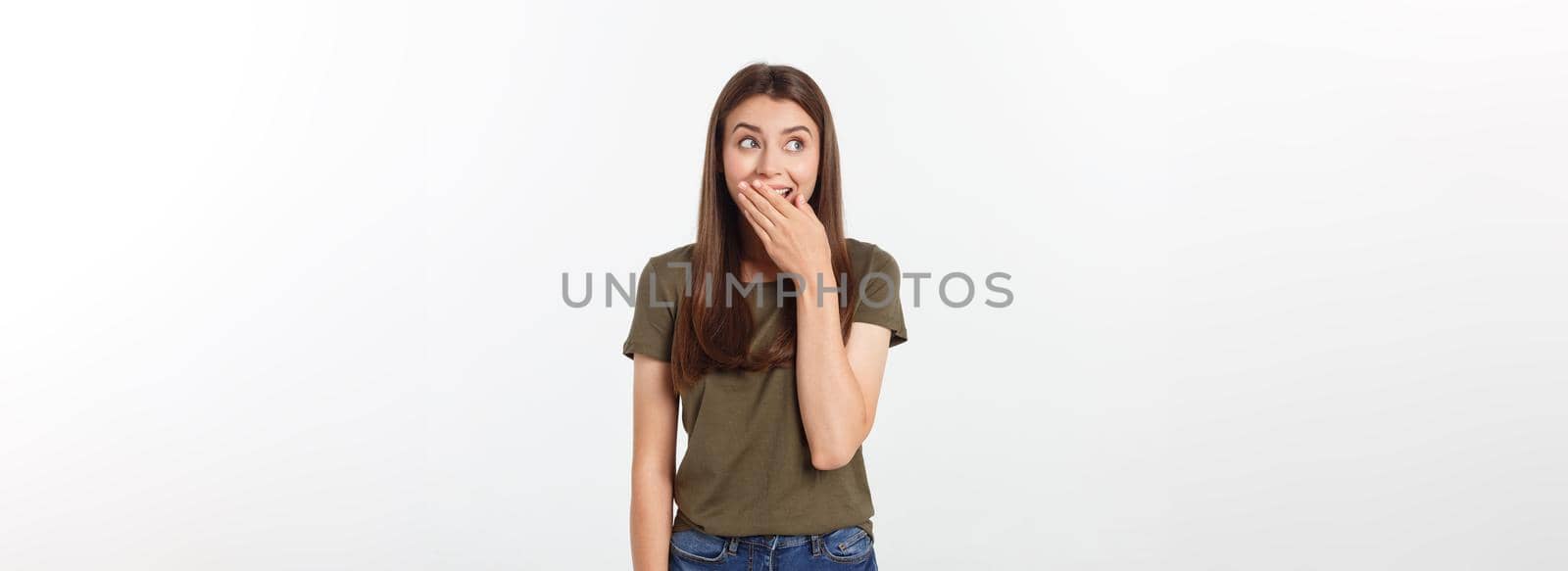Close-up portrait of surprised beautiful girl holding her head in amazement and open-mouthed. Over white background by Benzoix
