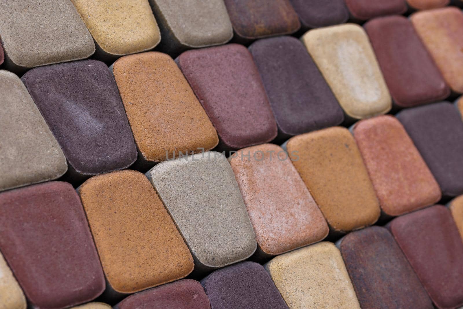 colored trapezoid concrete tiles pavement with rounded corners in diagonal perspective.