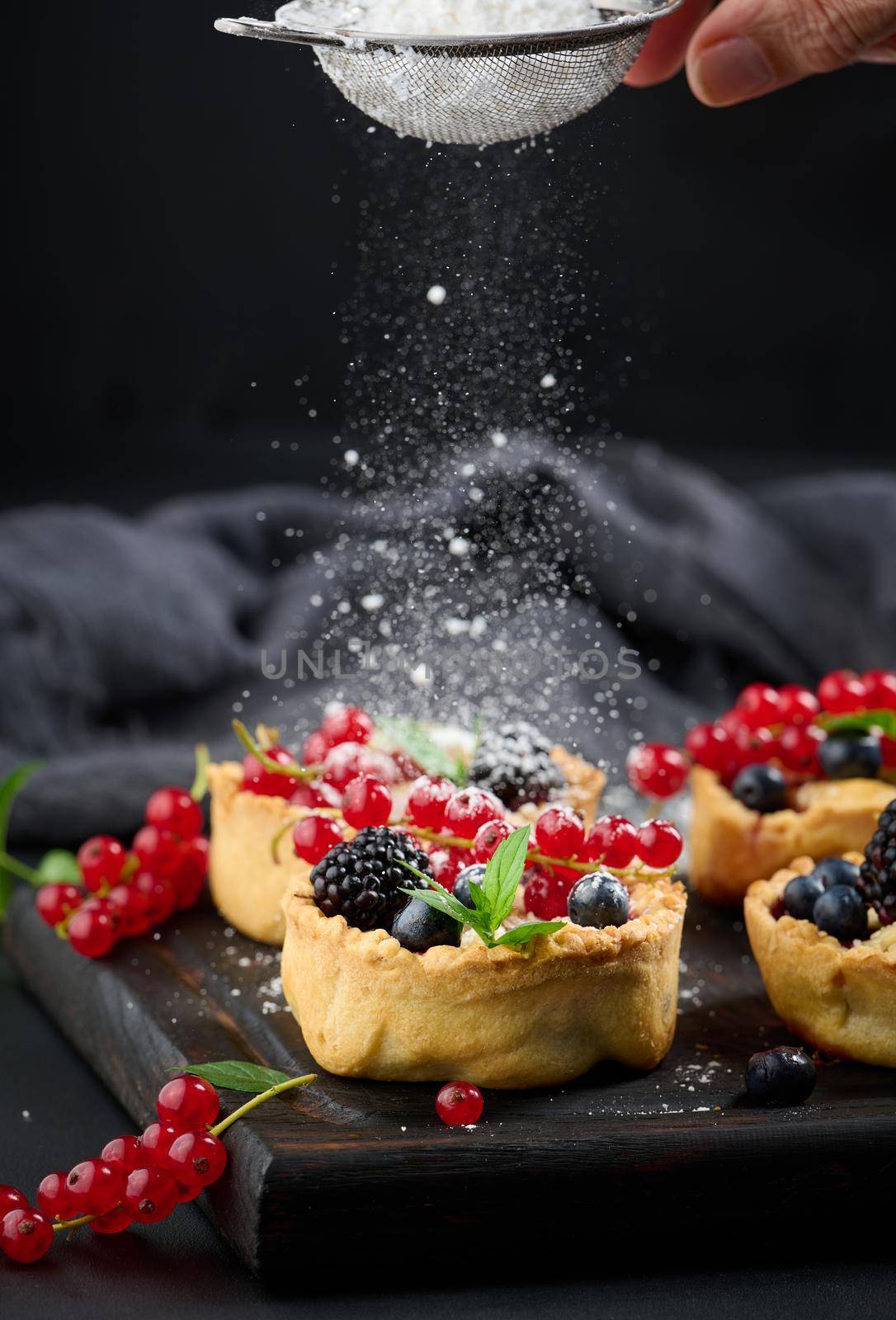 Ripe red cherries in a plate on a white table, close up by ndanko