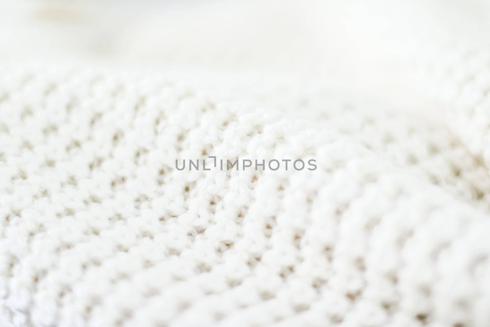 Knitwear, fabric textures and handmade items concept - Warm knitted clothes, soft and white