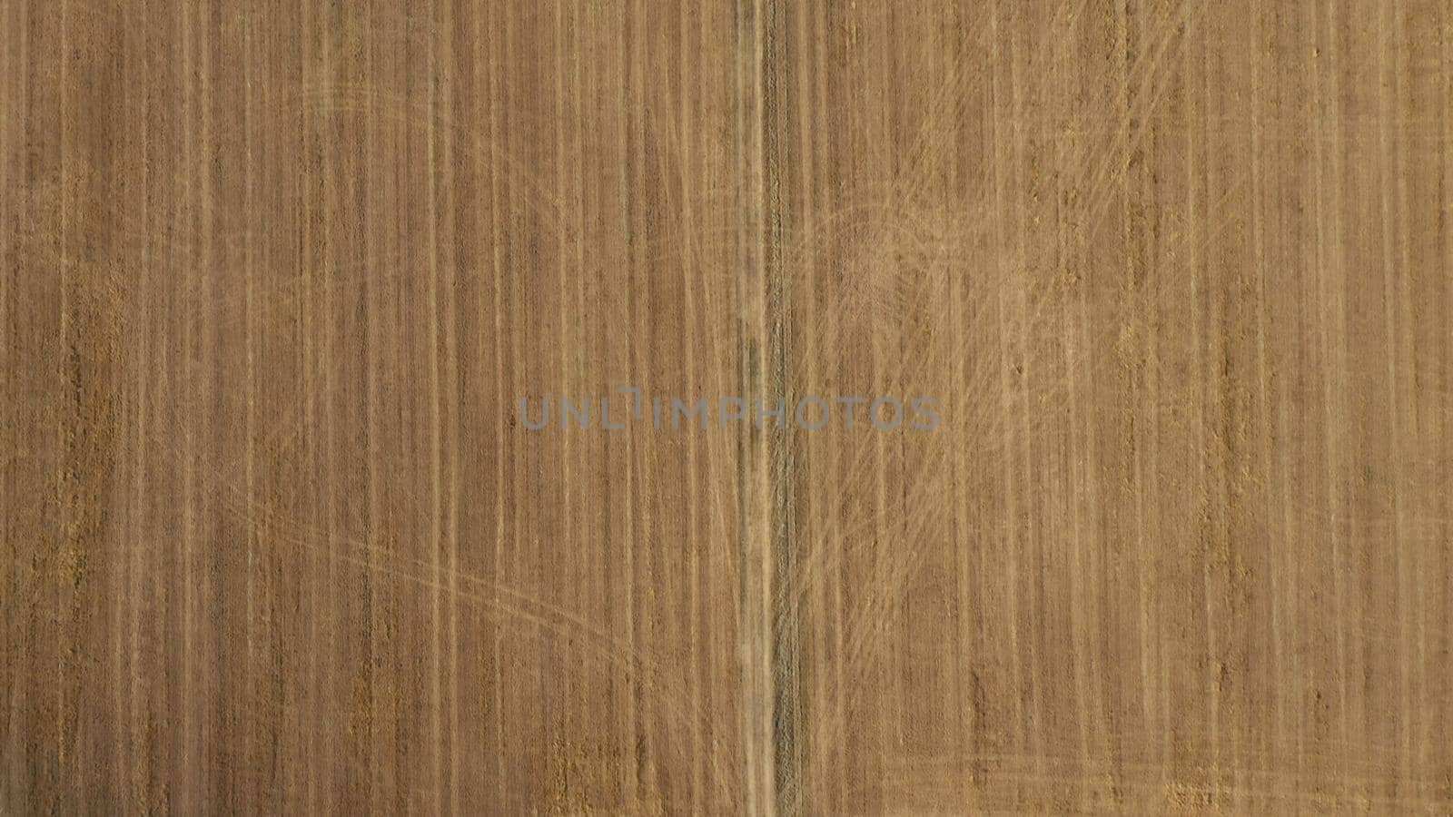 Top Down Aerial View of Green and Yellow Wheat Field Farm and Greenhouses. Golden Crops During Pasture Aerial View. Agricultural Work in Summer During Drought. Grain Crisis. Nature, Harvesting, Eco