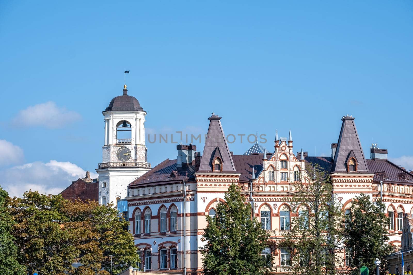 Vyborg, Leningrad region, Russia. - August 27, 2022. View of a beautiful old residential building and the historic Clock Tower. Selective focus.