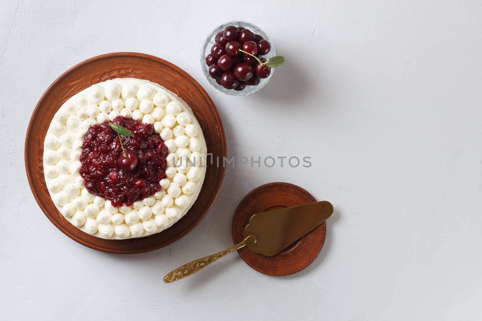 Biscuit cake, cherry soufflé with cream cheese and cherry confiture on a gray background. copy space