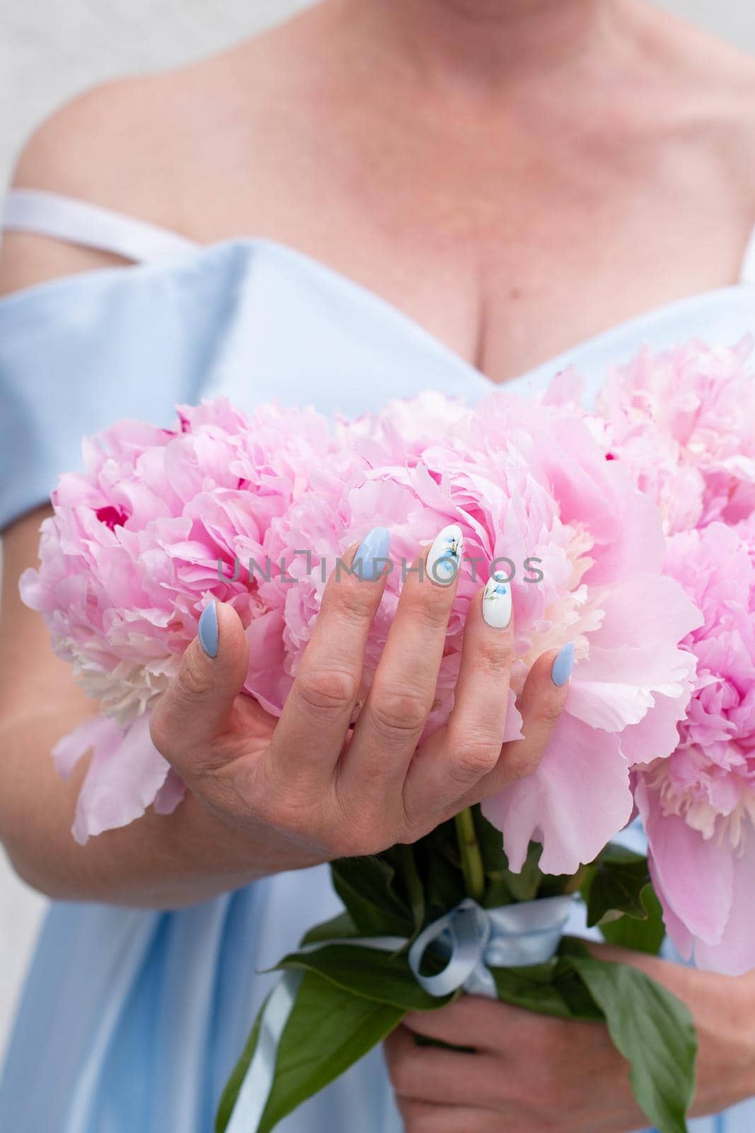 bride in a blue wedding dress with a bouquet of pink peonies, pastel paradise, floral background, complementary color combination. High quality photo