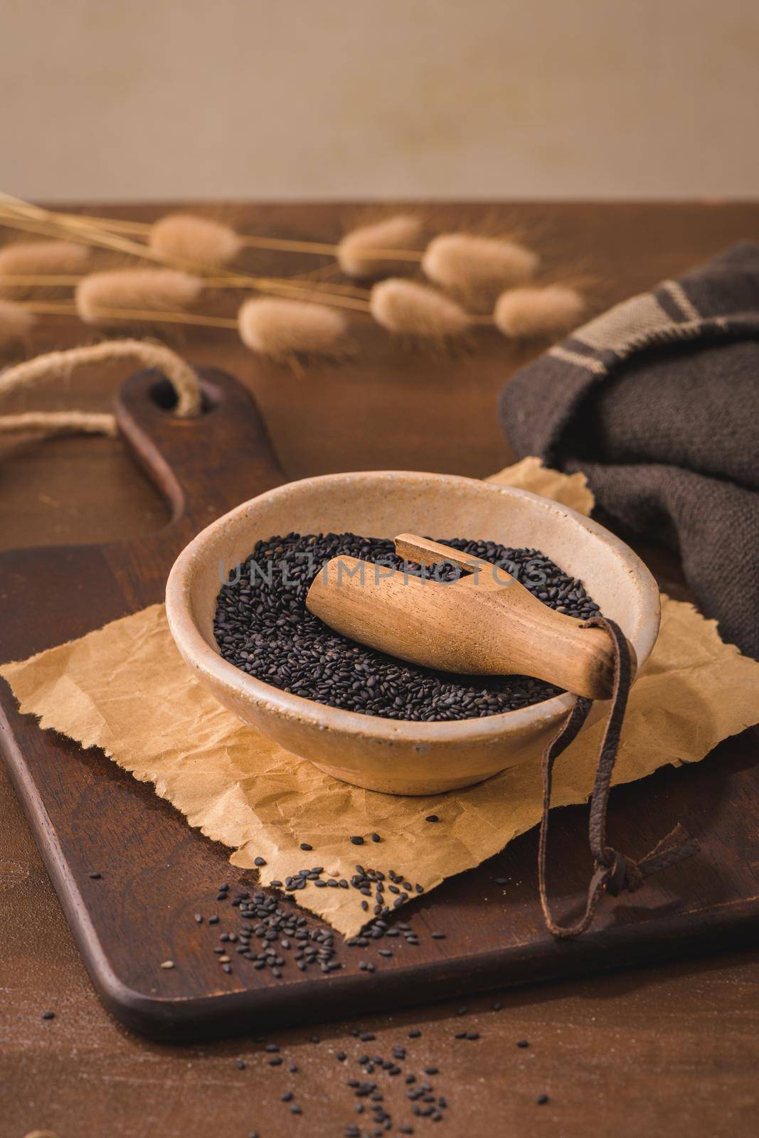 Black sesame seeds in a ceramic bowl  by homydesign
