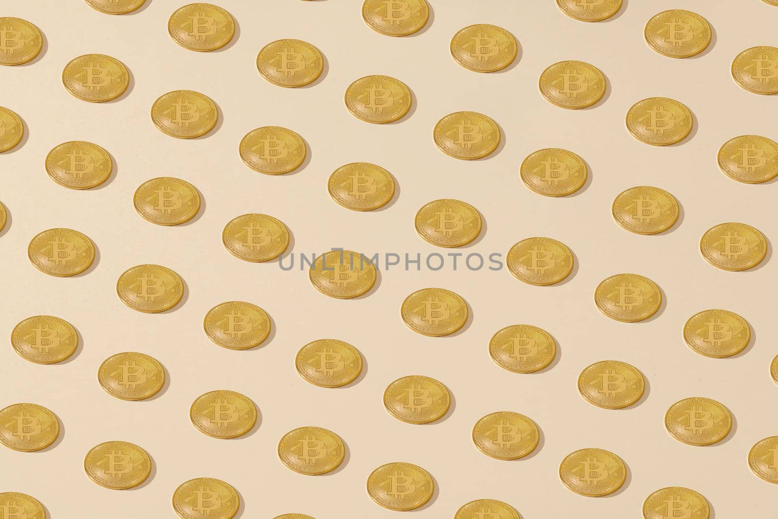 Bitcoin. Isometrically placed golden yellow bitcoin coins on a cream background