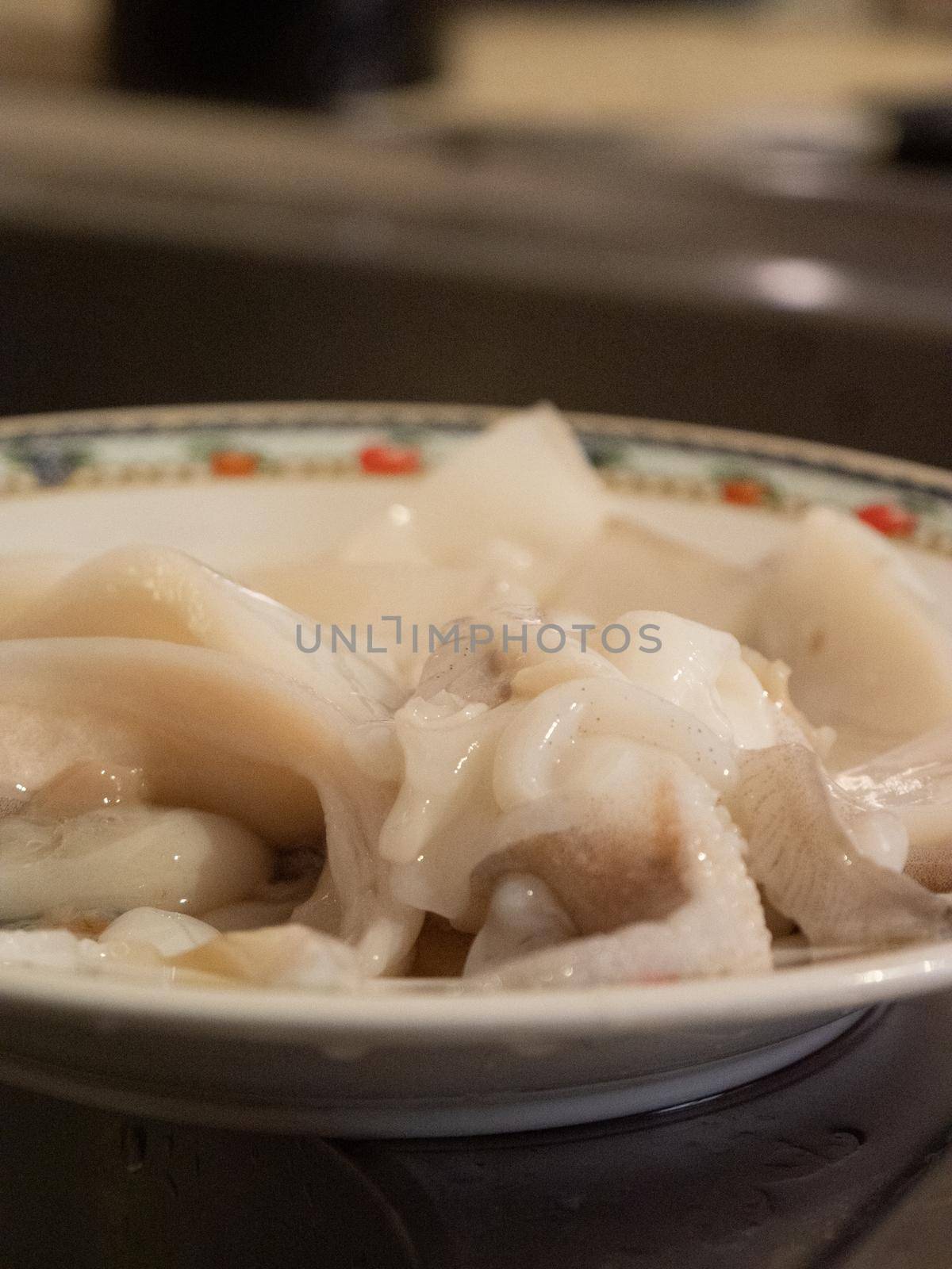 cleaning a raw adriatic cuttlefish at home in Numana, Marche, Italy