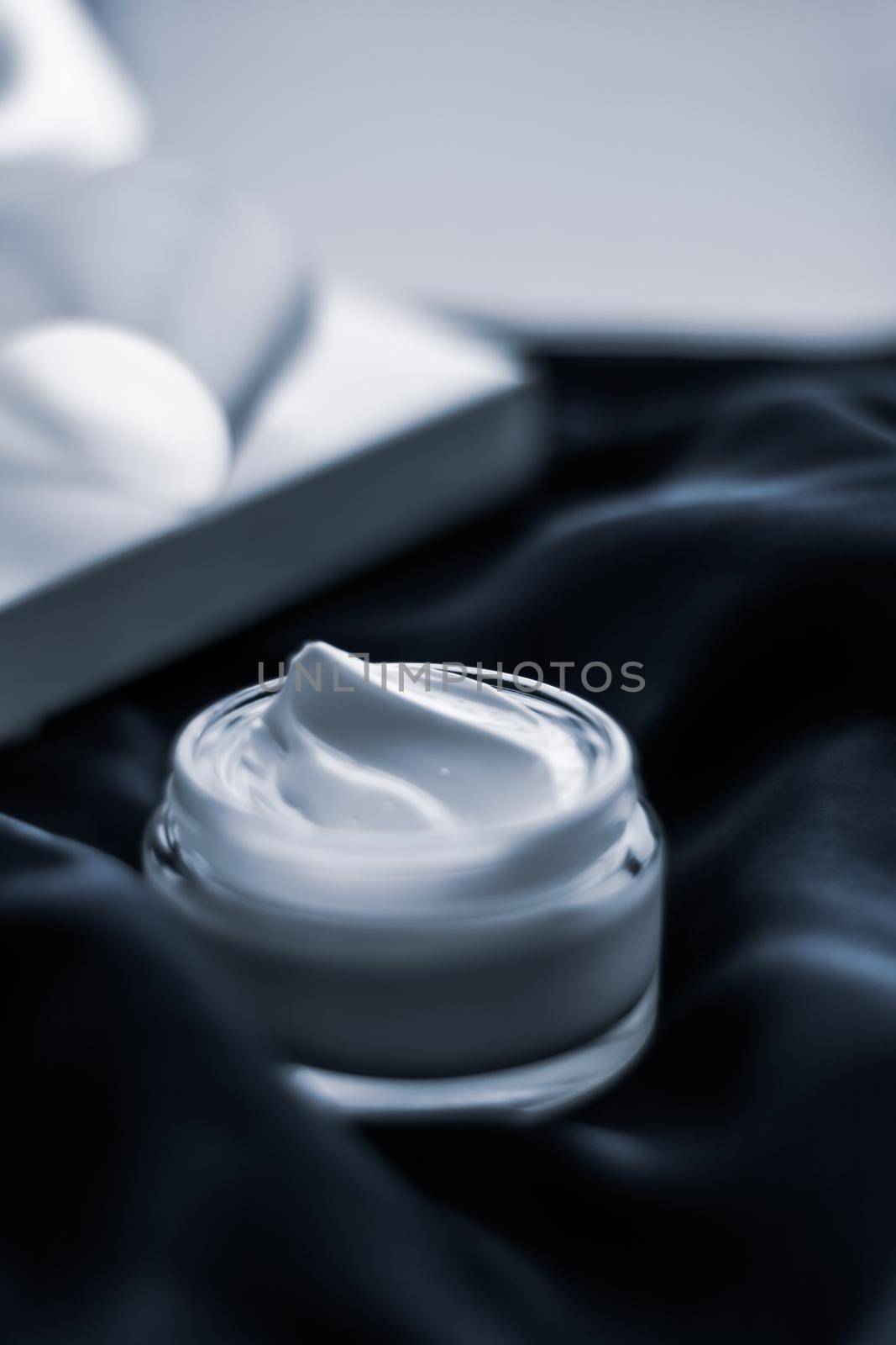 Beauty, cosmetics and skincare styled concept - Luxury moisturizing cream and a gift box on black silk