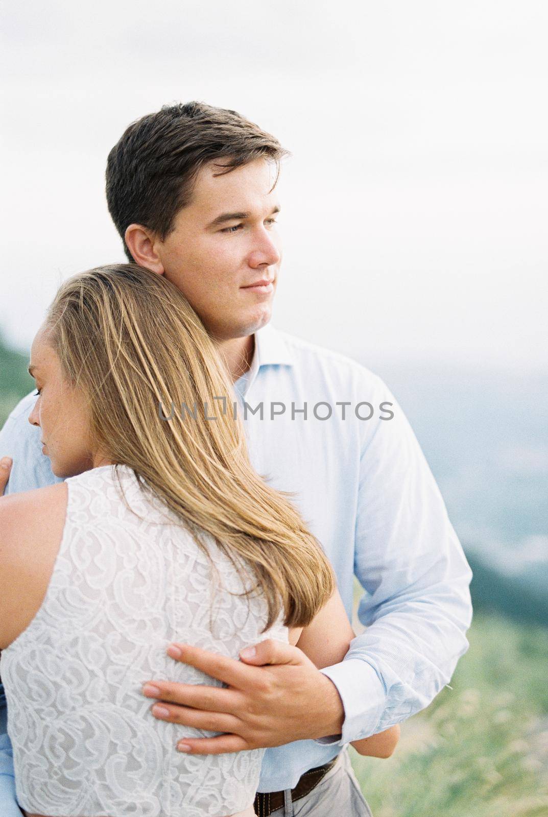 Man hugging a woman in the mountains. Portrait. High quality photo