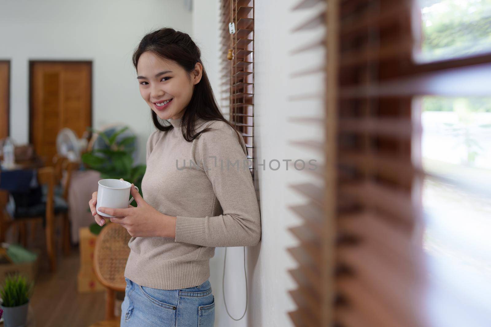 Beautiful woman relaxing and drinking coffee in morning at home.