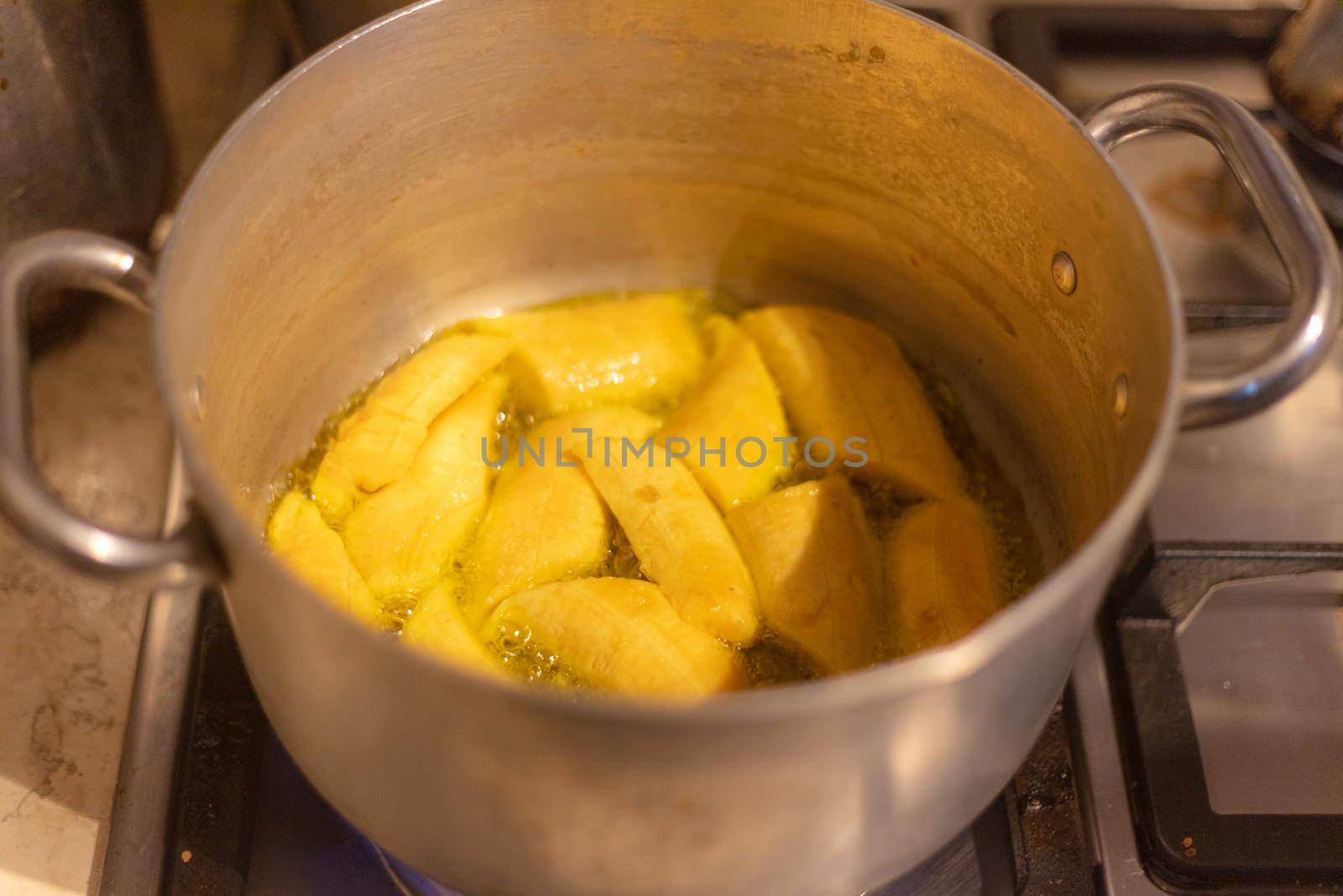 woman chef preparing african caribbean food with plantain plane tree fruit