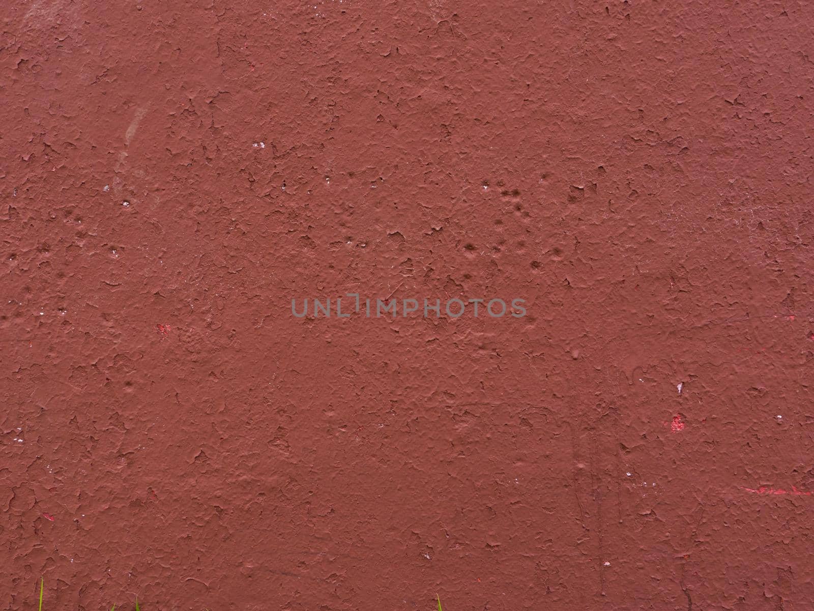 Old wall covered with red paint. Art brown concrete stone texture for background.