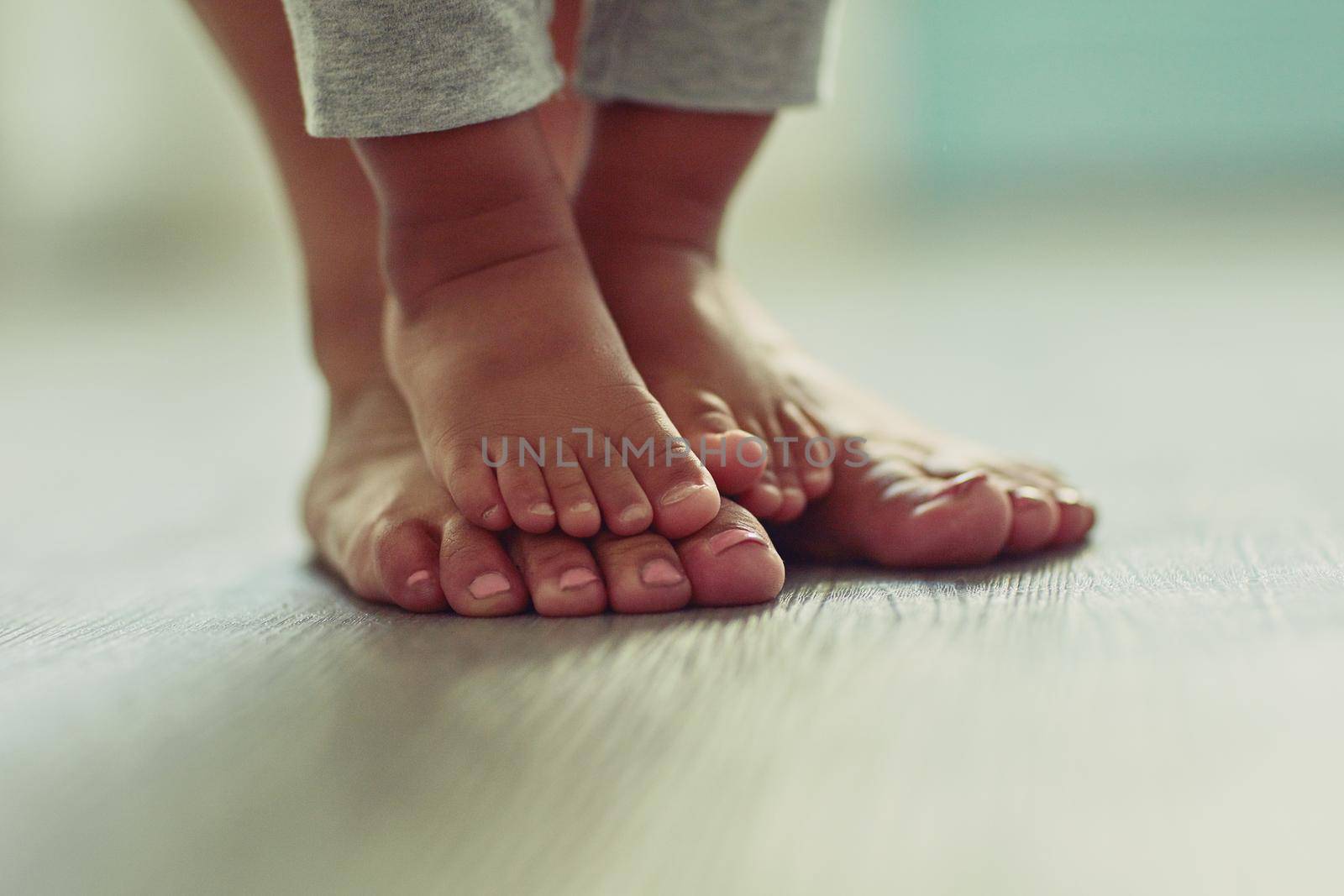 Little feet make my life so very sweet. an unrecognizable mothers feet and her childs feet at home. by YuriArcurs