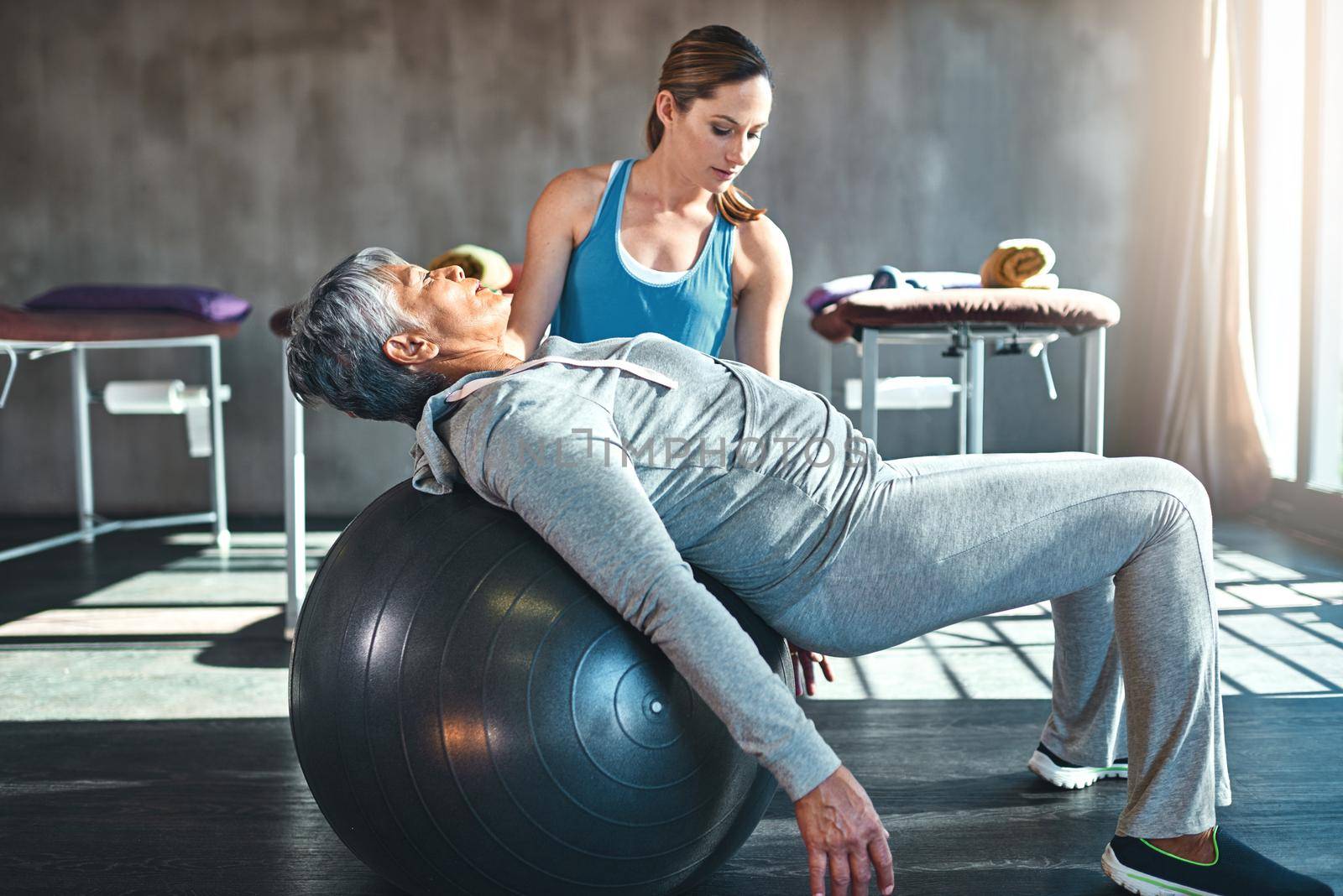 Her lifestyle is geared towards longevity. a senior woman working out with her physiotherapist