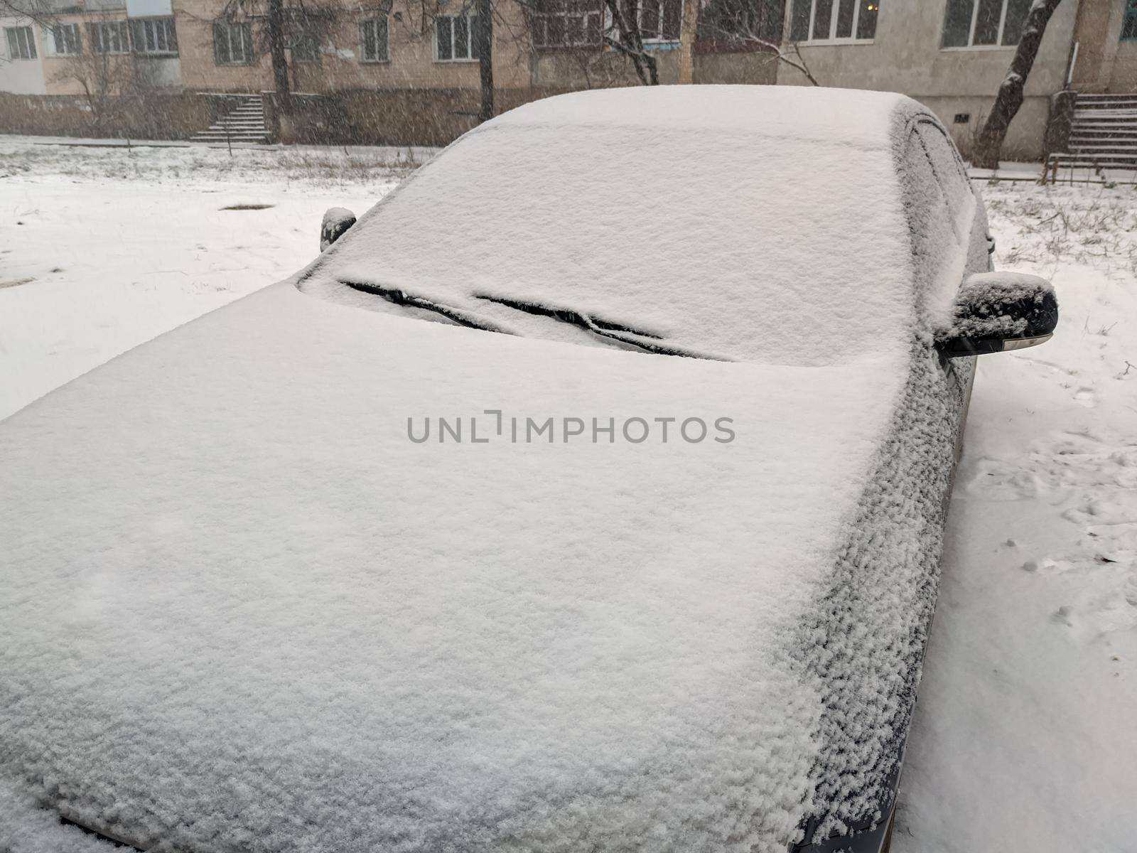 Closeup image of frosen car wipes lying on windshield.