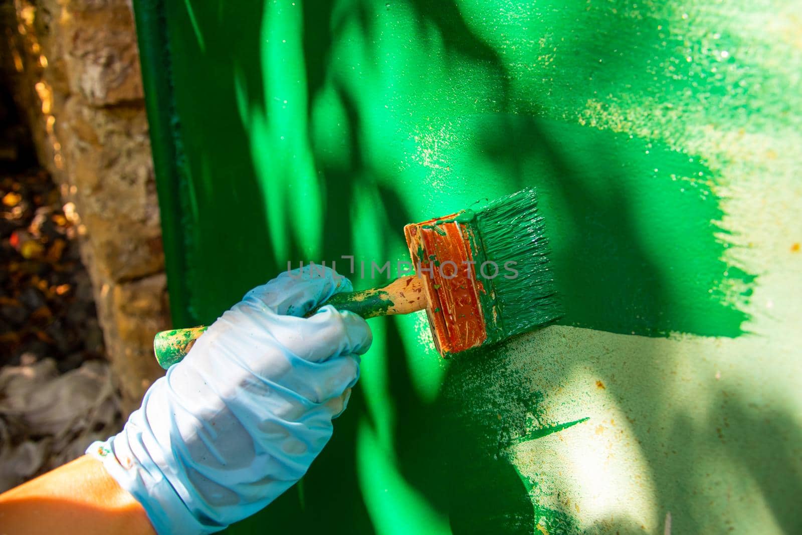 a man's hand paints the wall with paint.