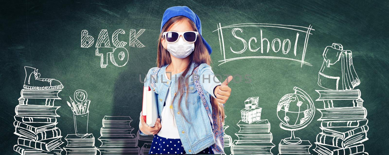 Young girl with protection mask against corona virus at school. by Taut