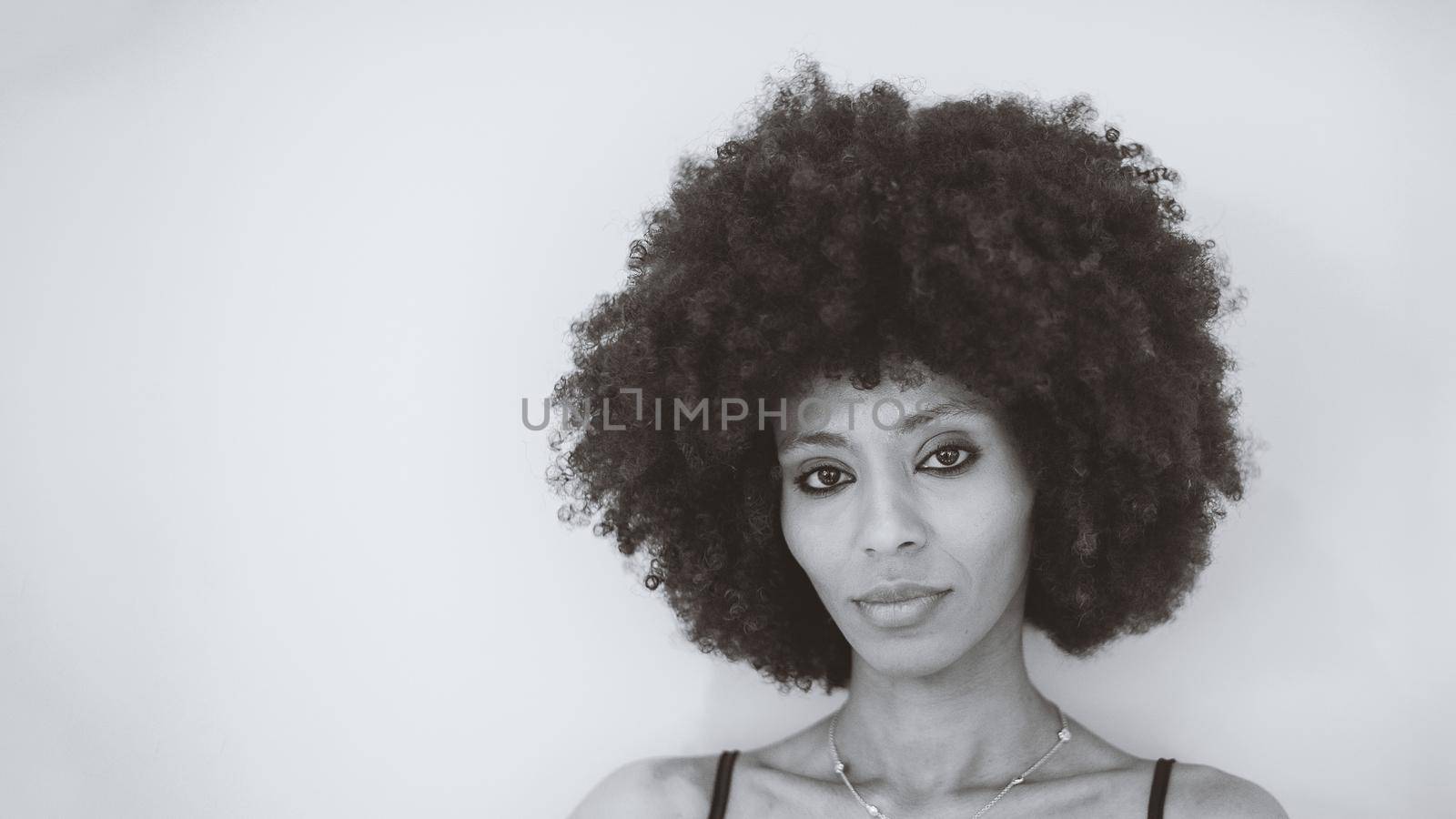 Young attractive African woman with happy cheerful smile having fun in studio