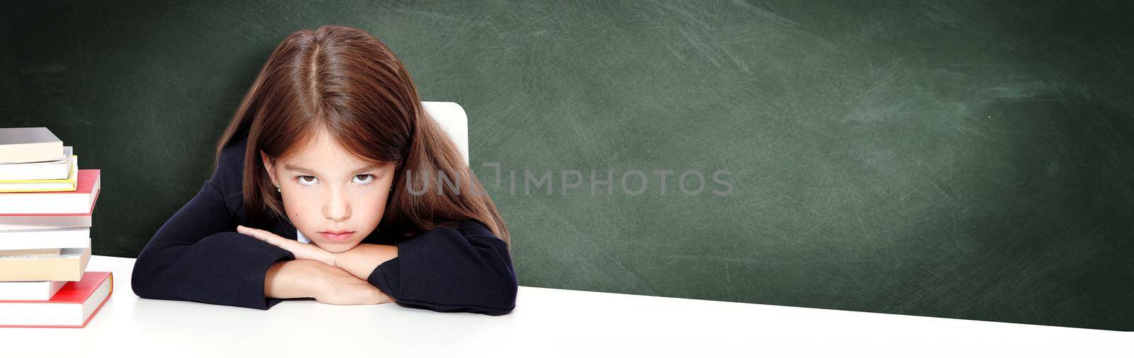 Frustrated and unhappy teen girl at school. by Taut