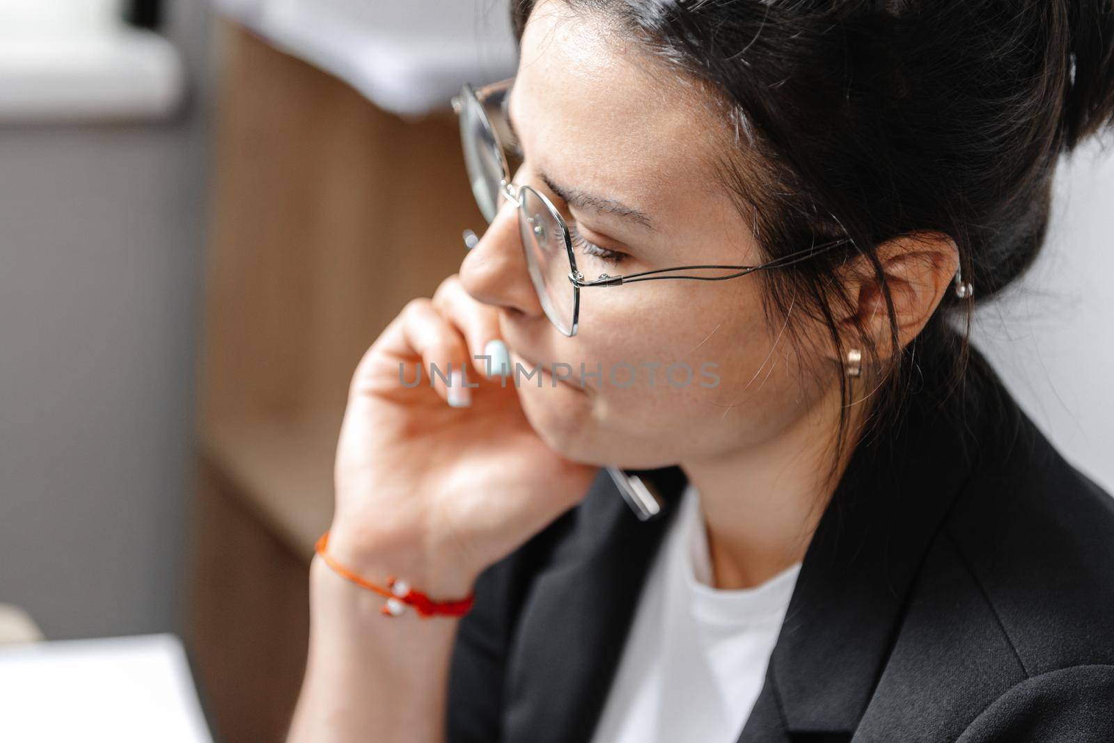 of a pretty thinking young girl, a girl working at home and thinking about an article. Close-up portrait by gulyaevstudio