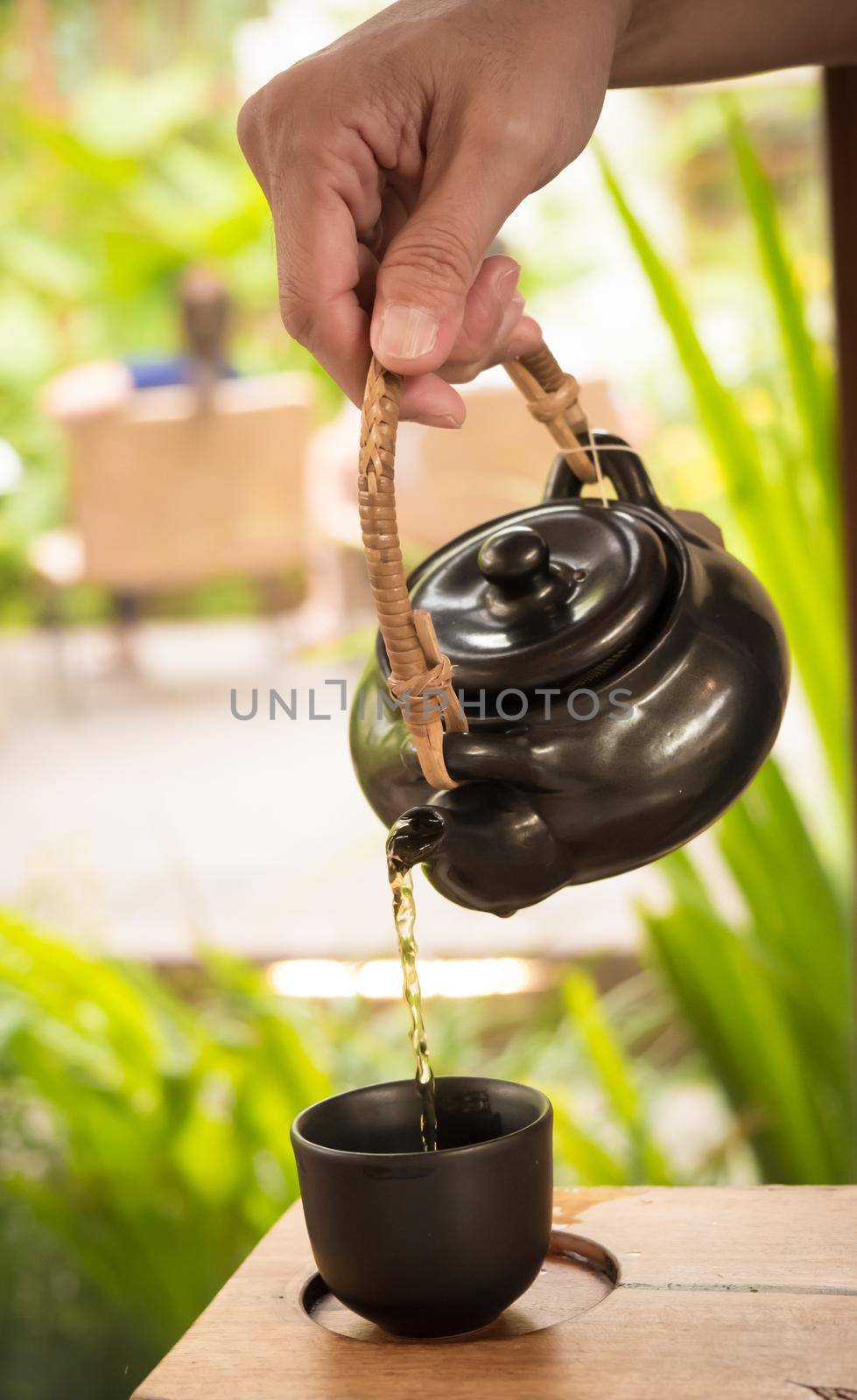 hand pour Chinese or Japanese traditional tea from clay pot