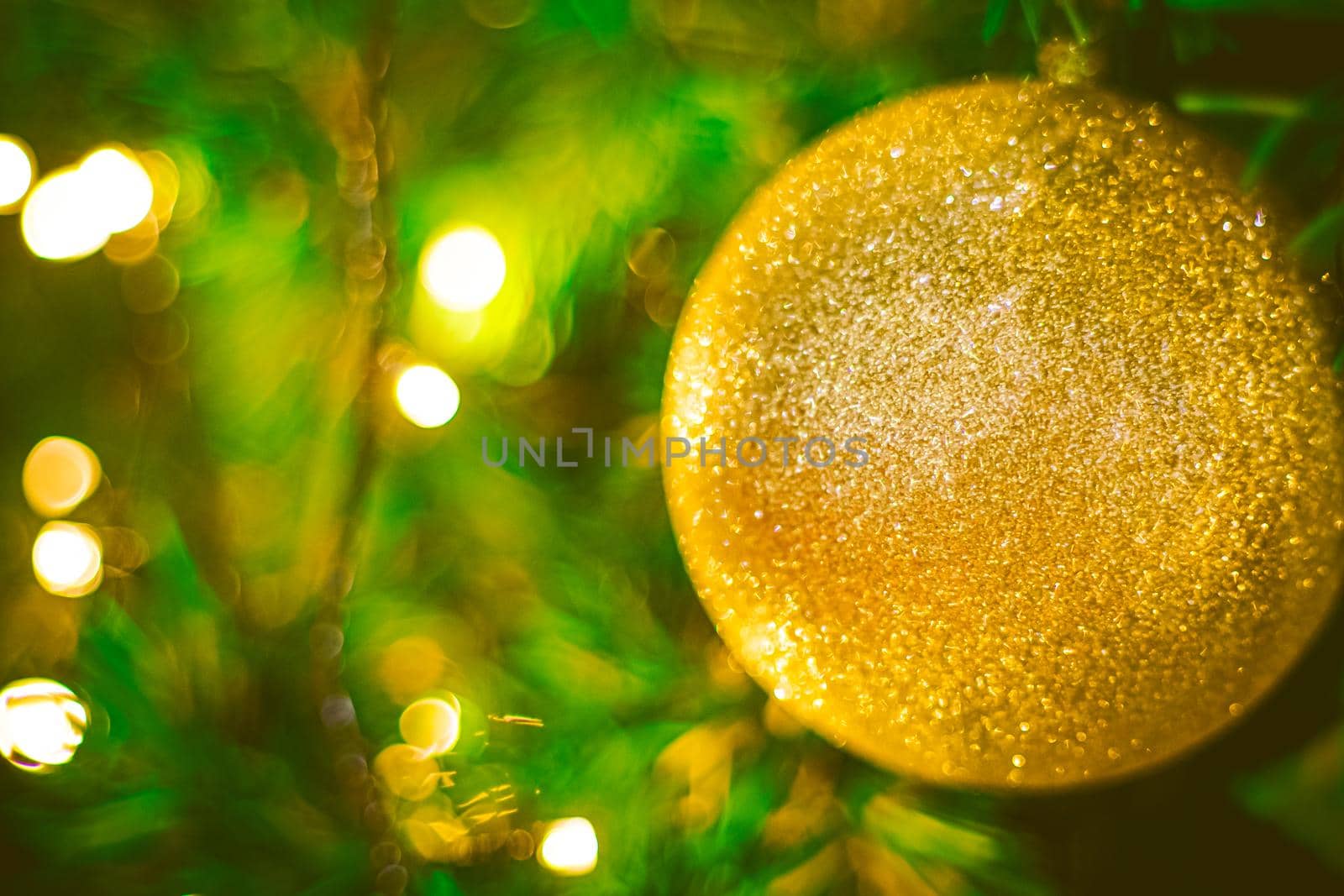Christmas ball decoration on yellow background. Colorful blur bokeh background. christmas background