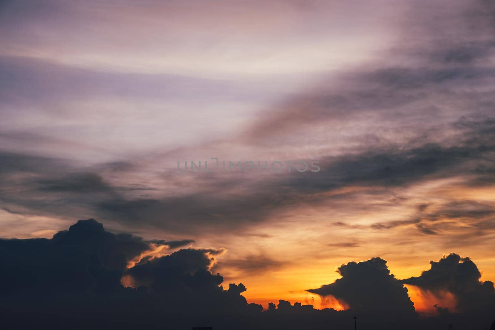 Dark fluffy clouds sky background with blue sky background for copy space.