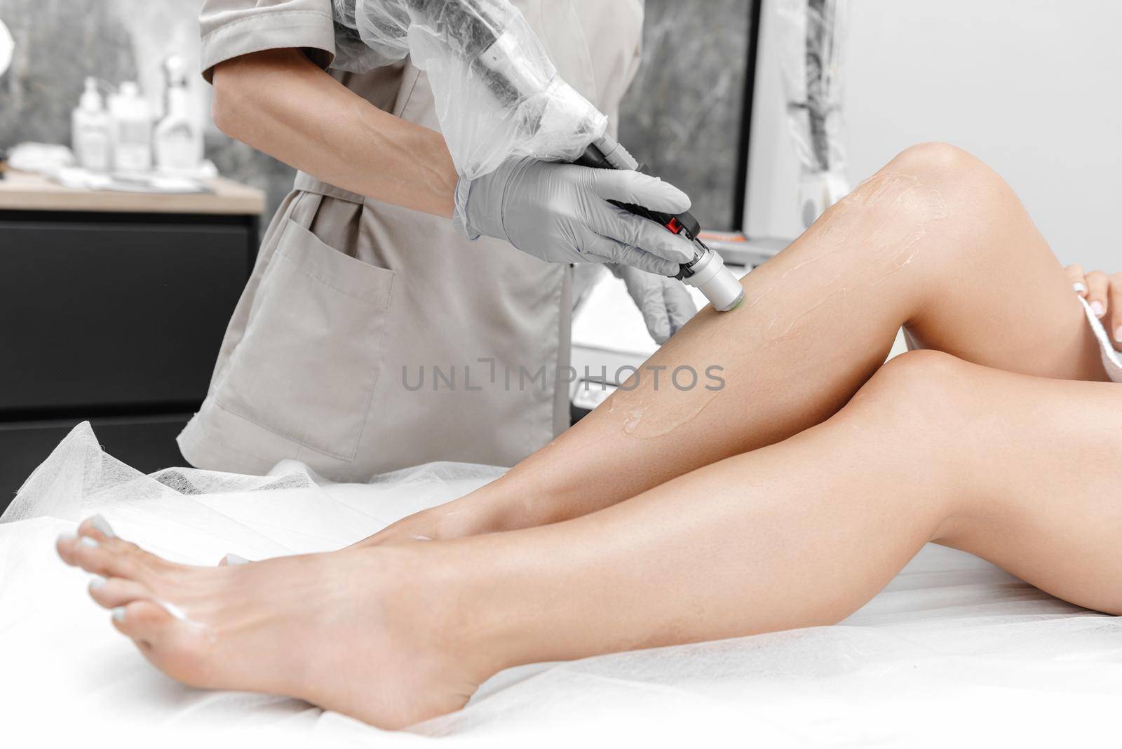 the process of laser hair removal on legs. Beautiful legs without hair. Hair removal on the legs.