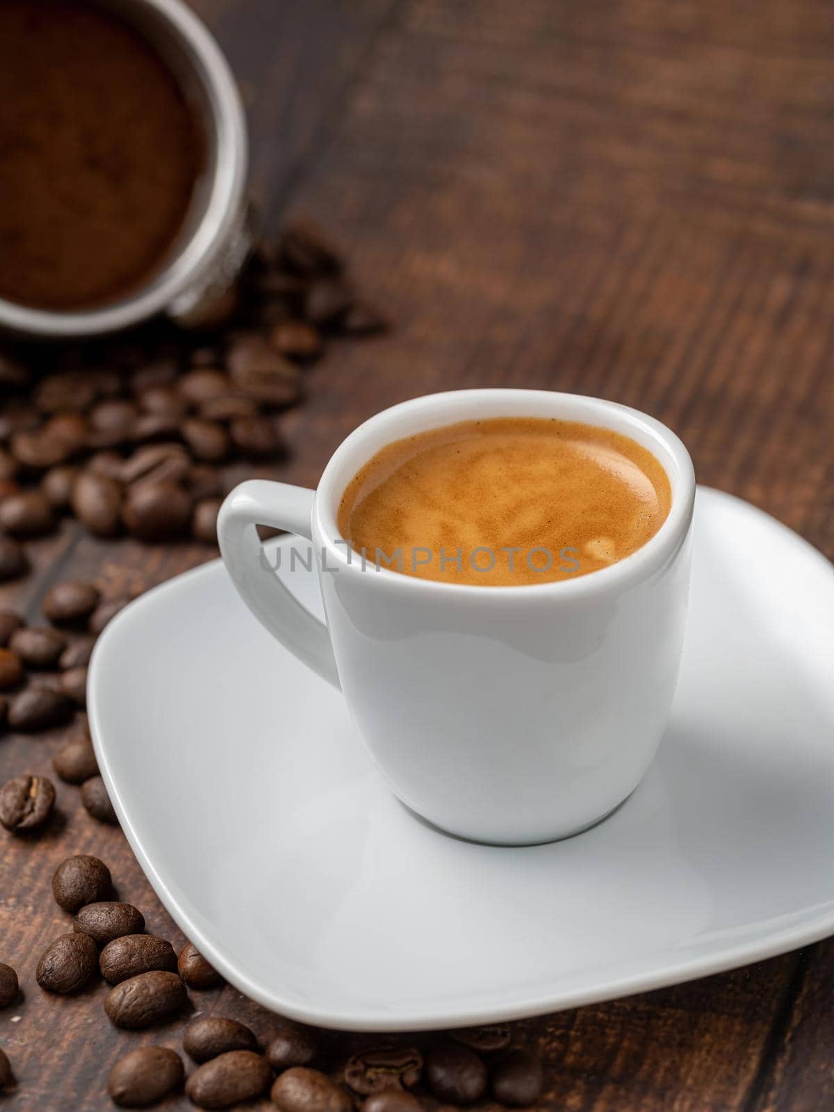 Fresh espresso coffee together decorated with coffee beans on wooden table