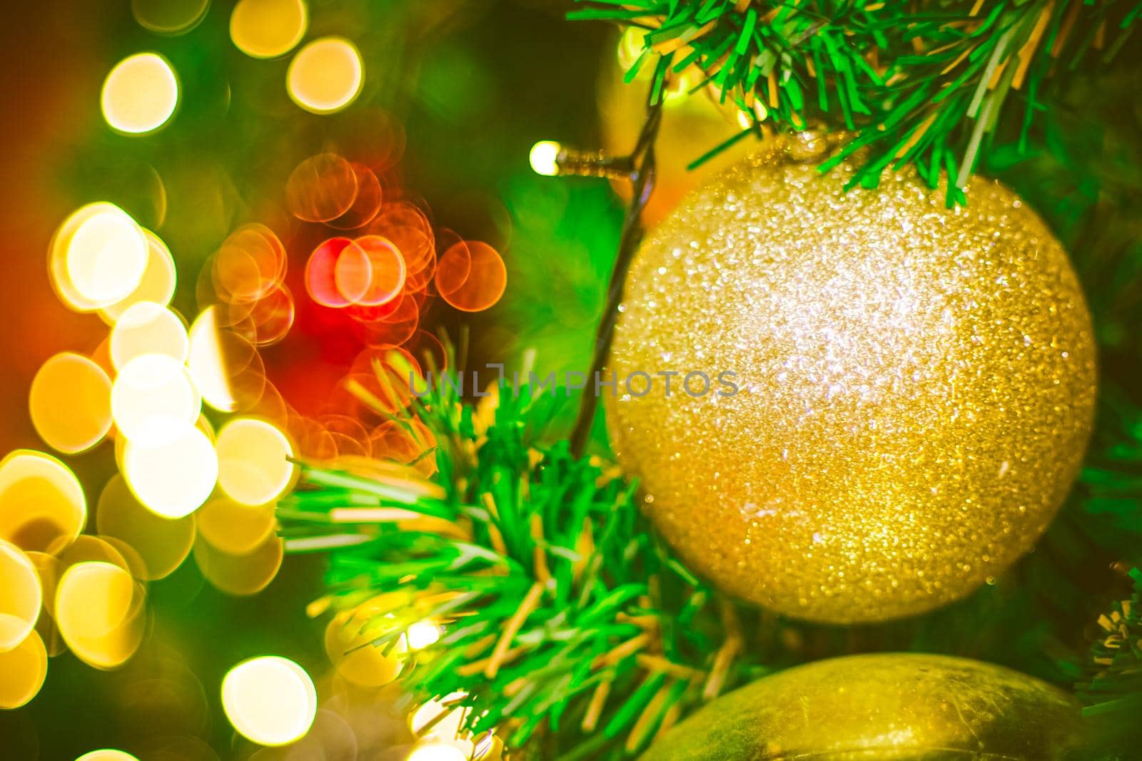 Christmas ball decoration on yellow background. Colorful blur bokeh background. christmas background