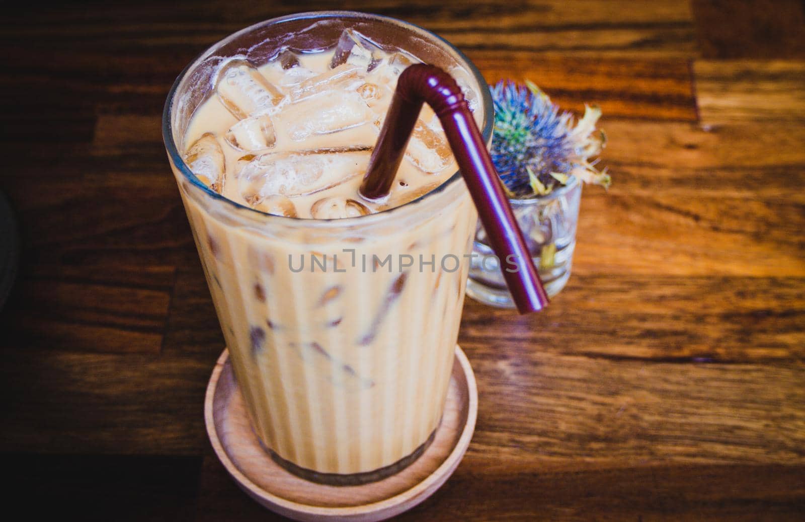 iced latte coffee in a glass with cream on bottom . cold summer drink background