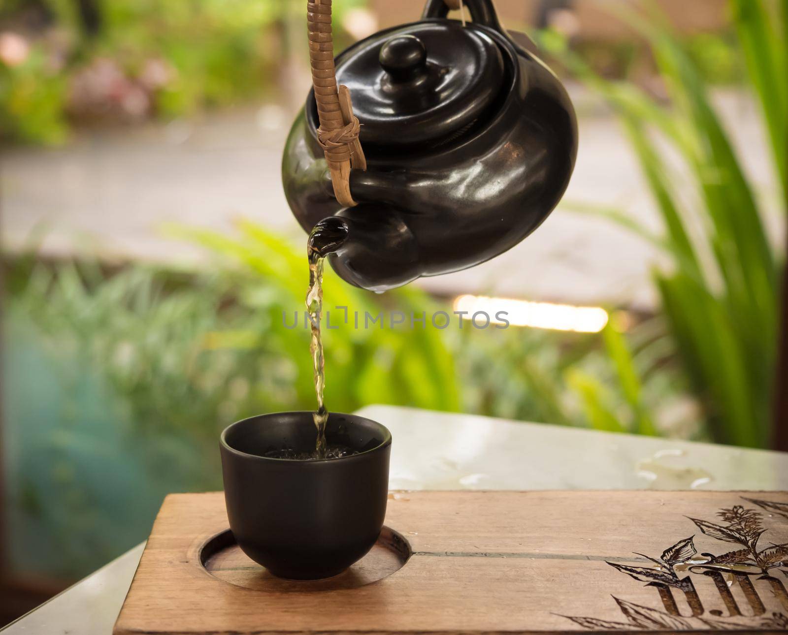 hand pour Chinese or Japanese traditional tea from clay pot