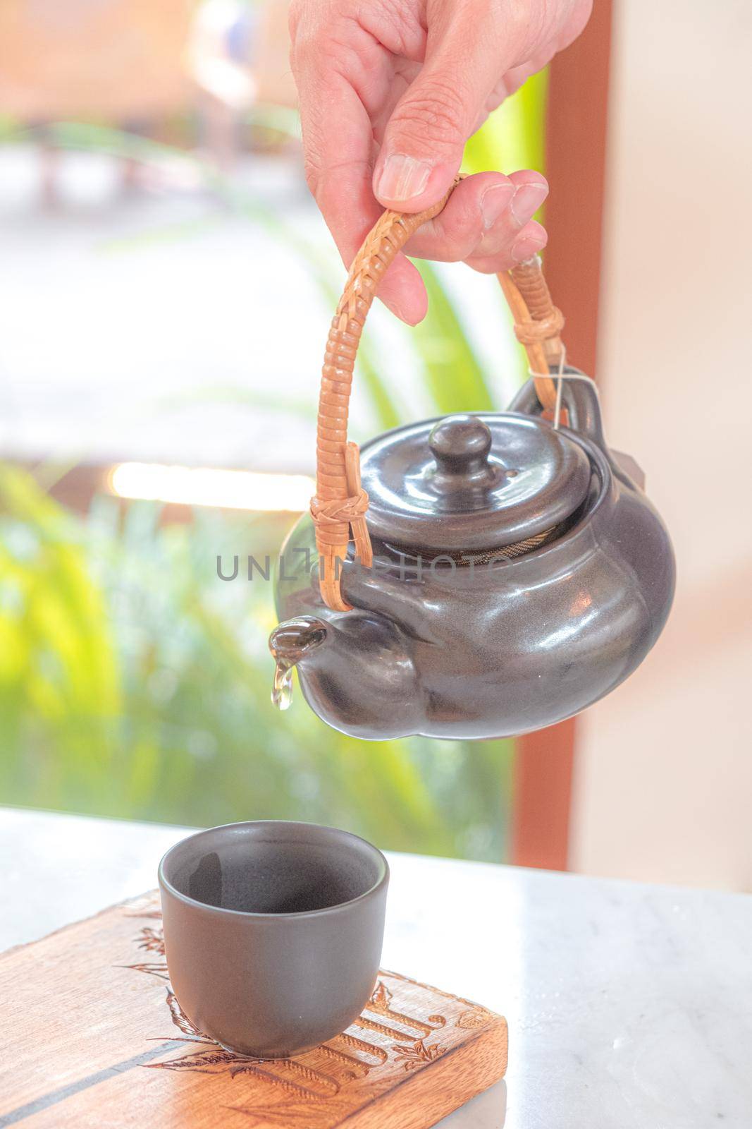 hand pour Chinese or Japanese traditional tea from clay pot